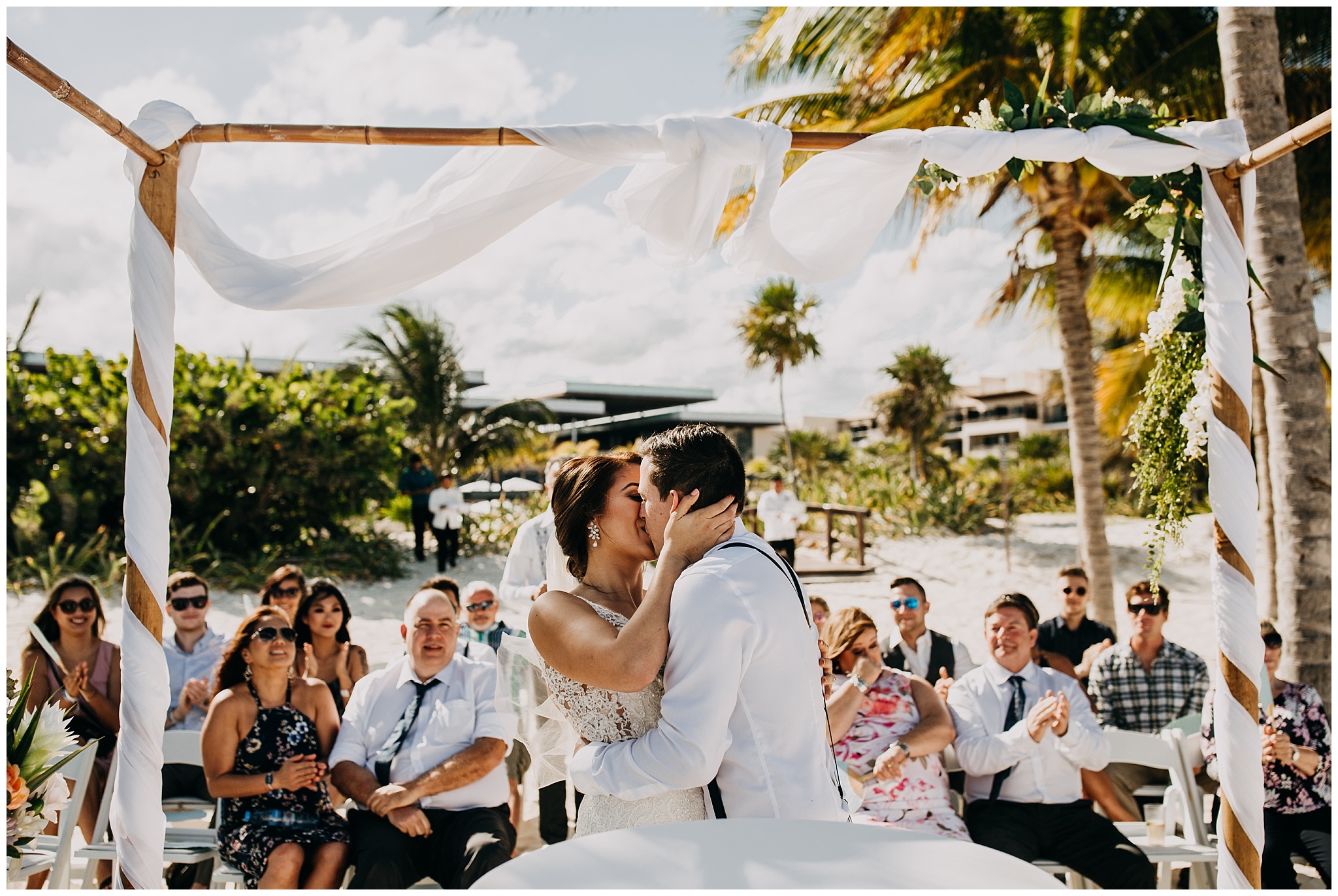 bride and groom first kiss at cancun mexico beach wedding