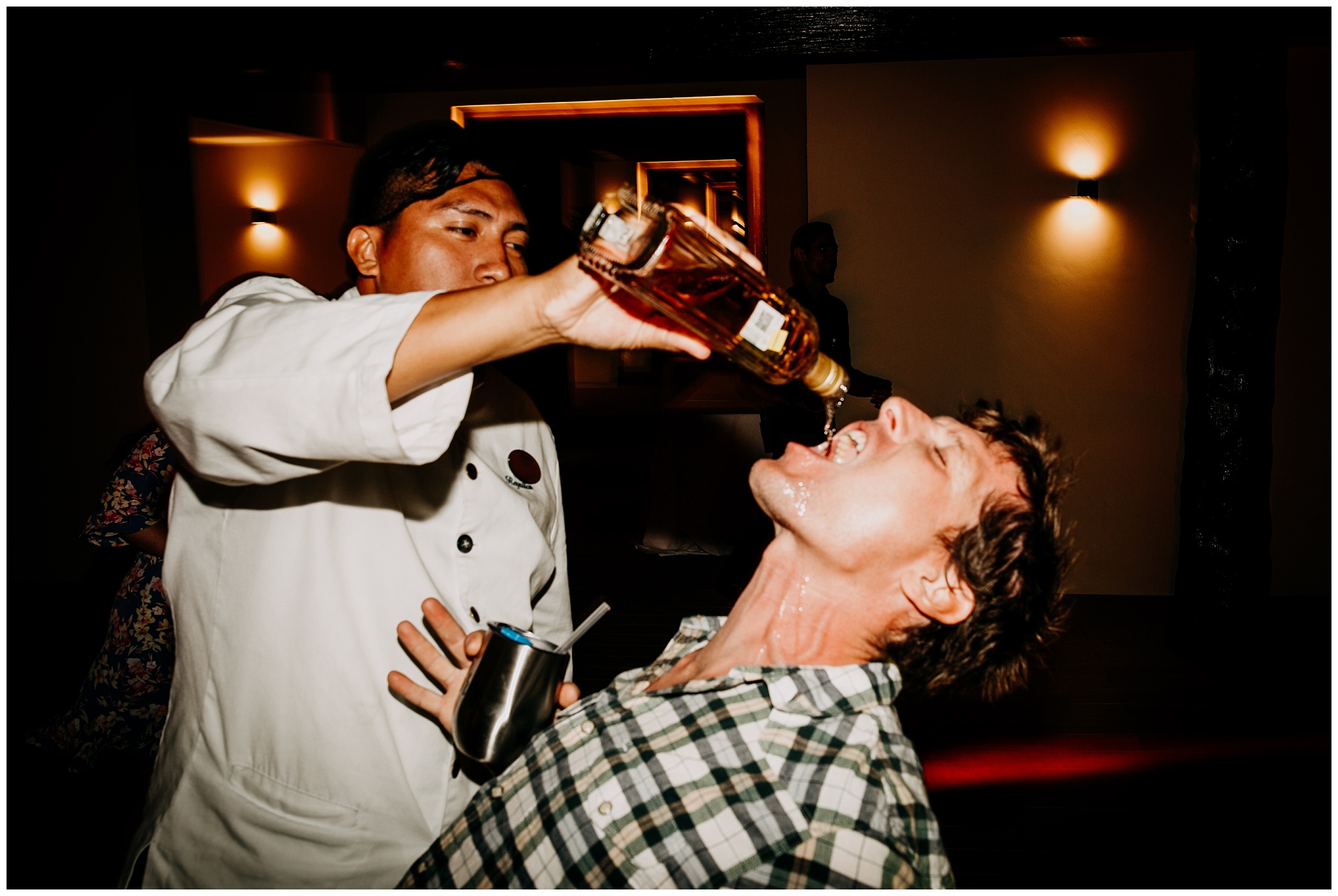 tequila poured down guest's mouth at cancun mexico wedding