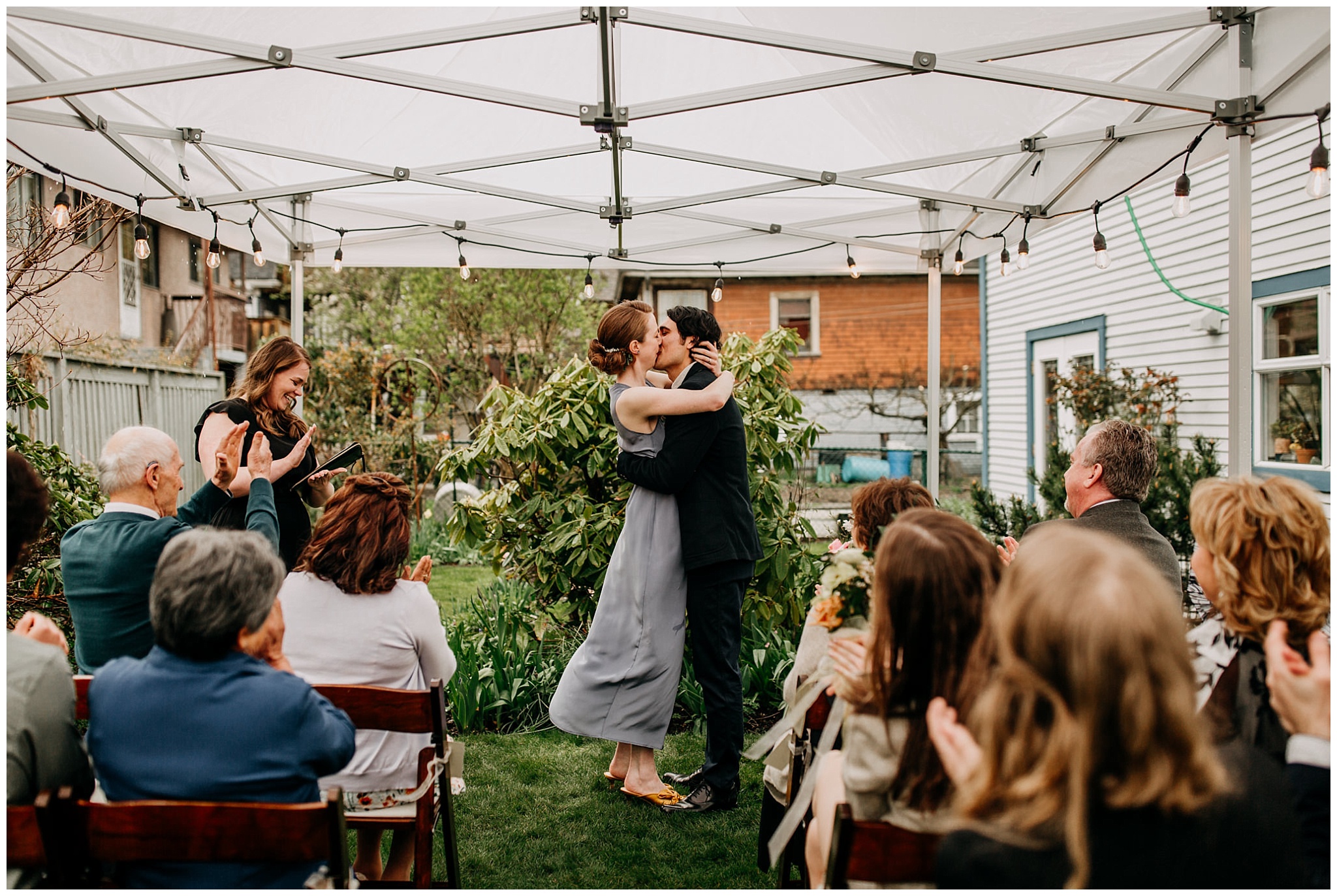bride and groom first kiss at vancouver backyard elopement