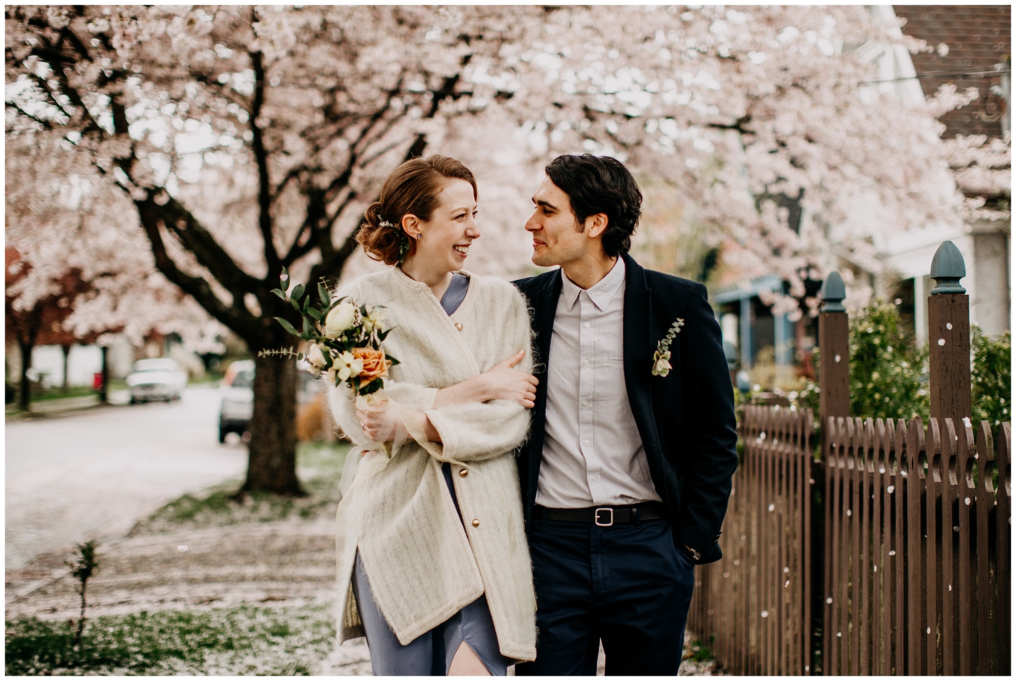 bride and groom portrait under cherry blossom tree in vancouver