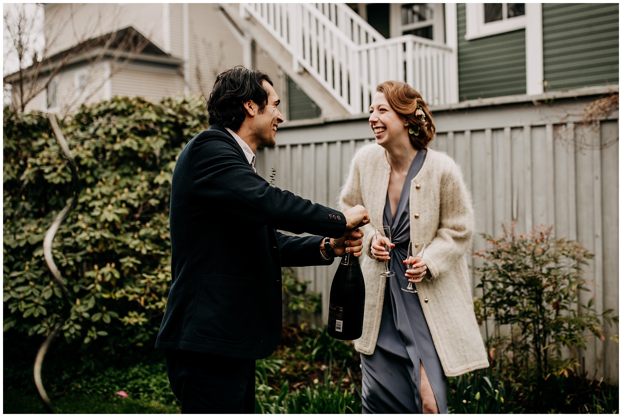 bride and groom popping champagne during vancouver backyard elopement