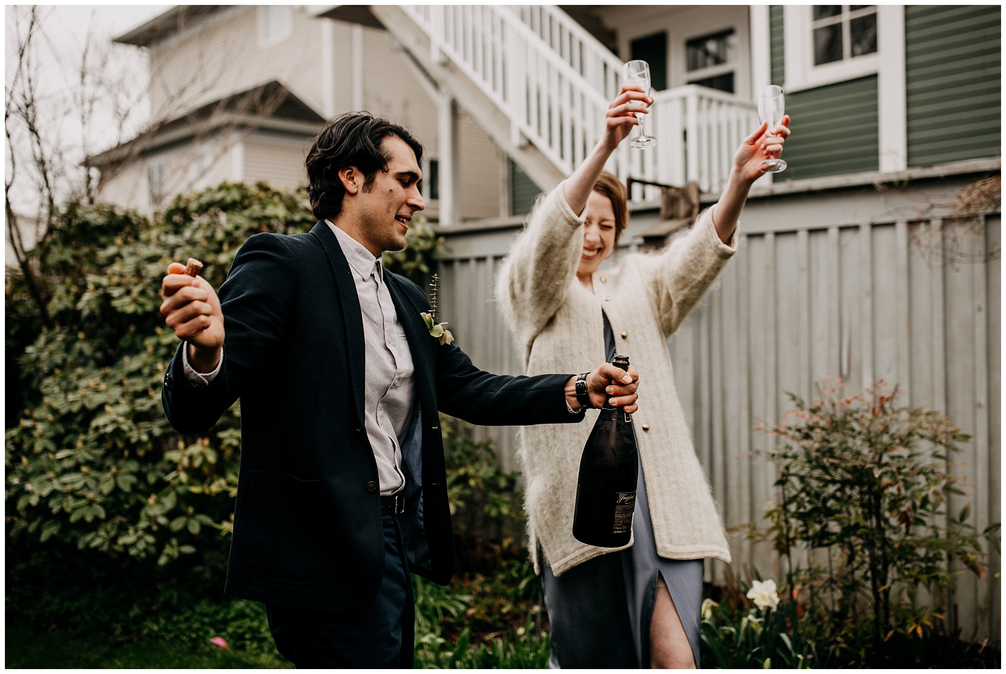wedding couple popping champagne during vancouver backyard elopement
