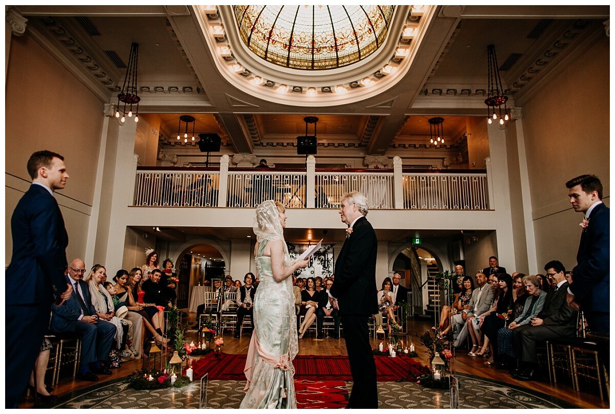 bride and groom exchanging vows during ceremony at the permanent wedding