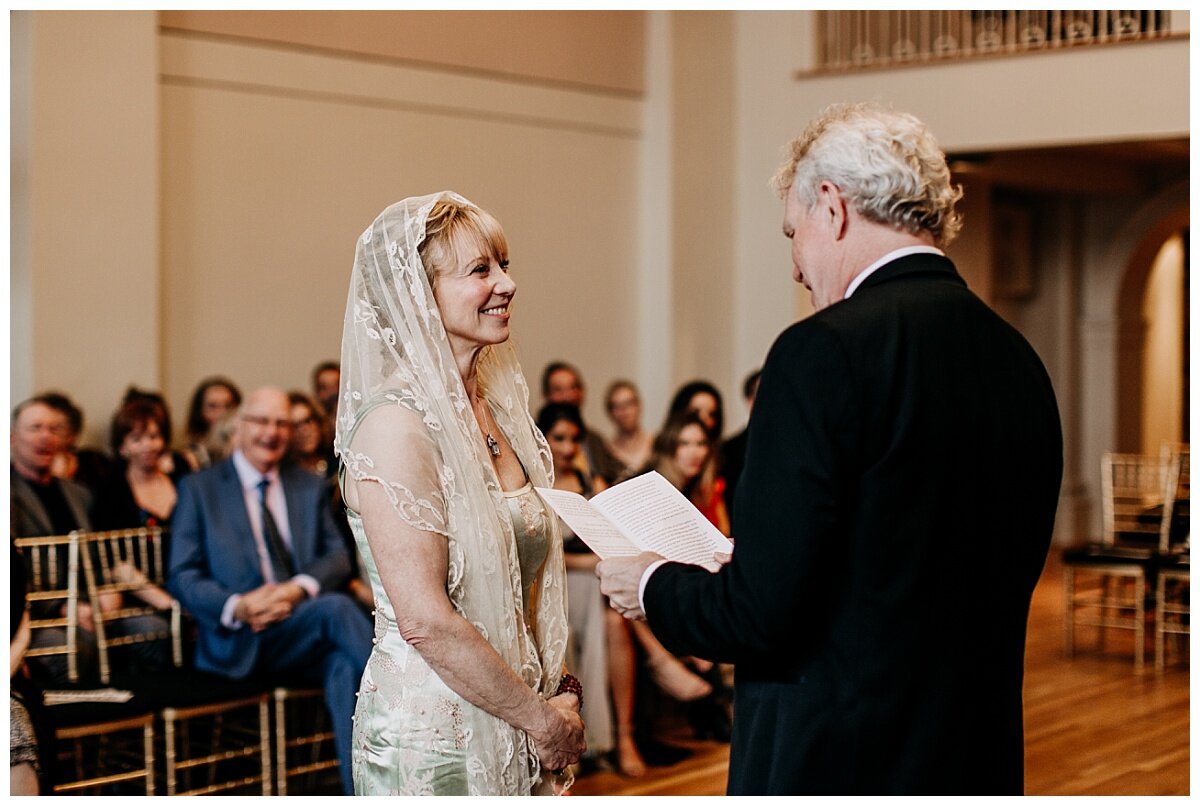 bride's reaction to groom's vows during ceremony at the permanent