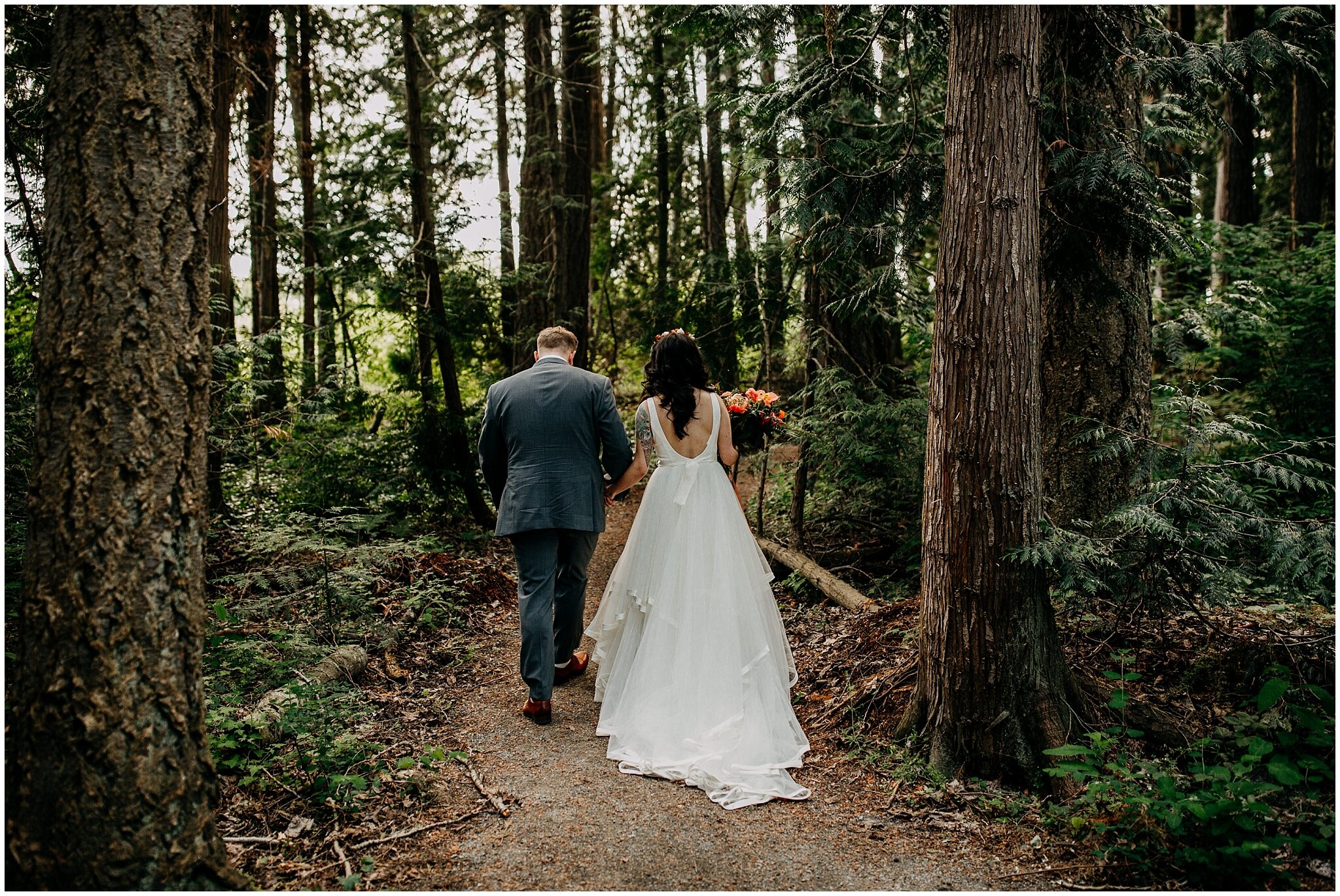 bride and groom walk through forest at sea cider farm and ciderhouse