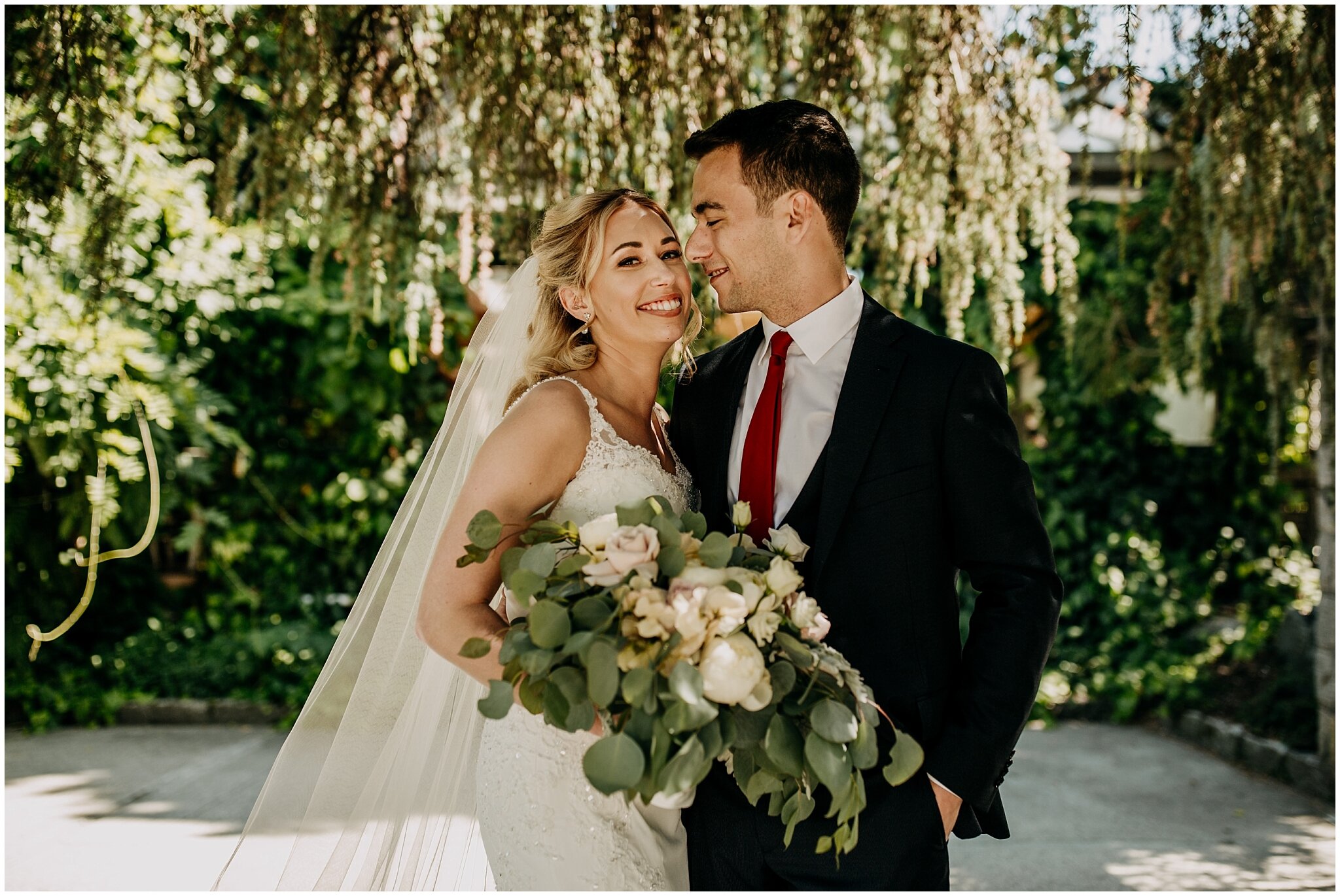 bride and groom portrait under floral canopy at shaughnessy restaurant wedding