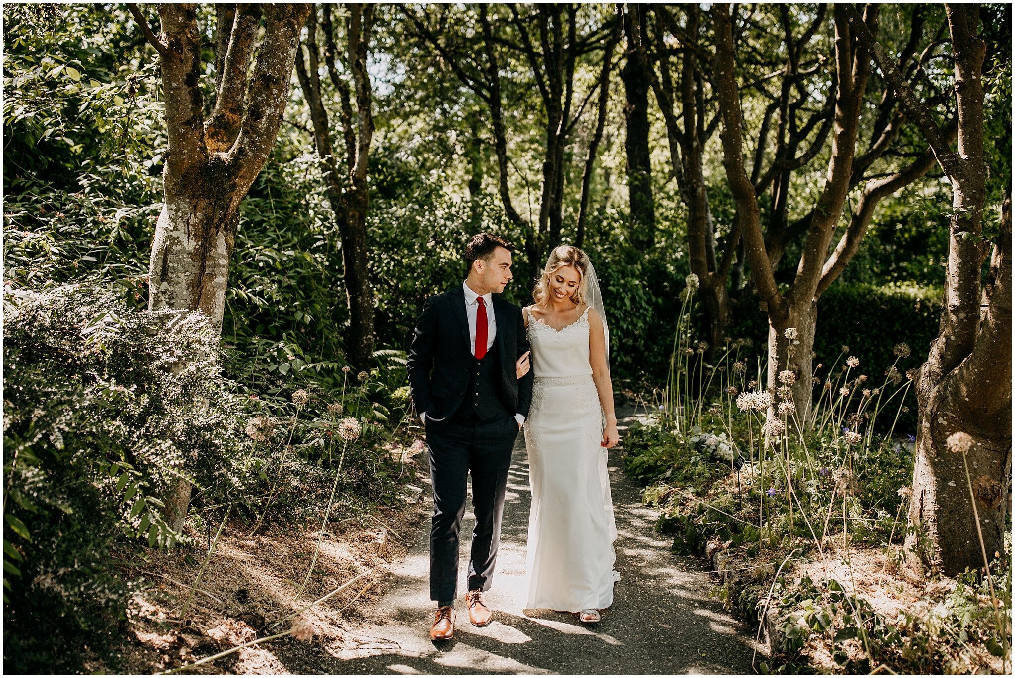 bride and groom walking through van dusen gardens