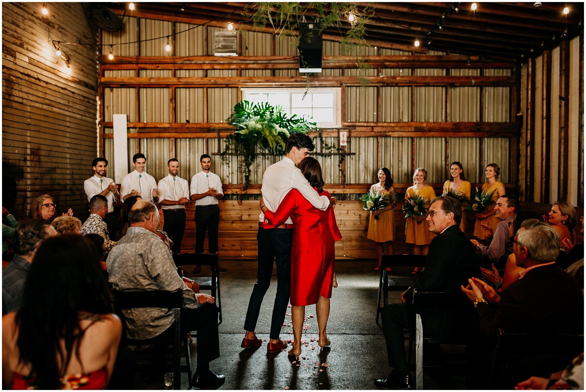 groom and mother walking down aisle at ellis building wedding