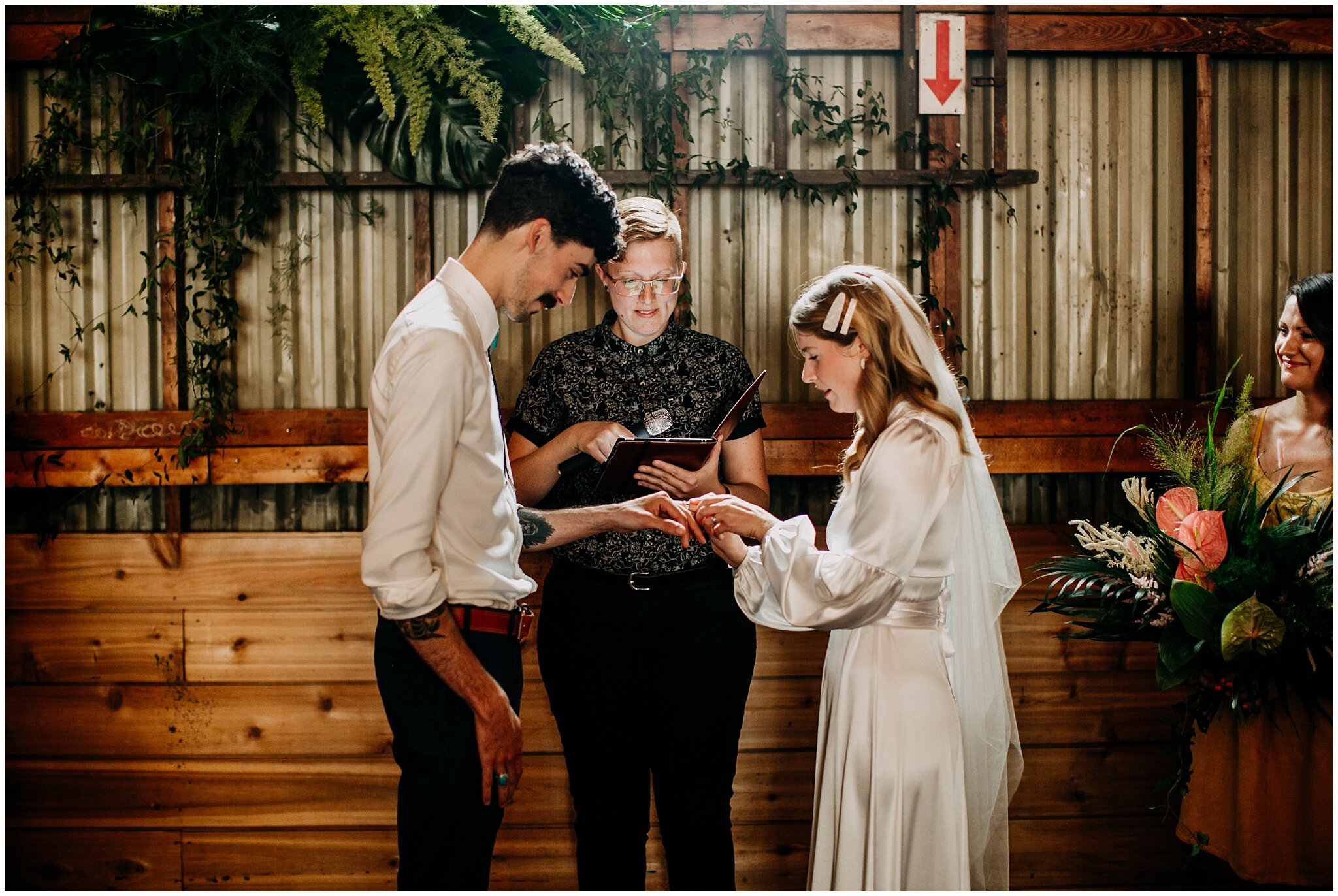 bride and groom exchanging rings at ellis building wedding ceremony