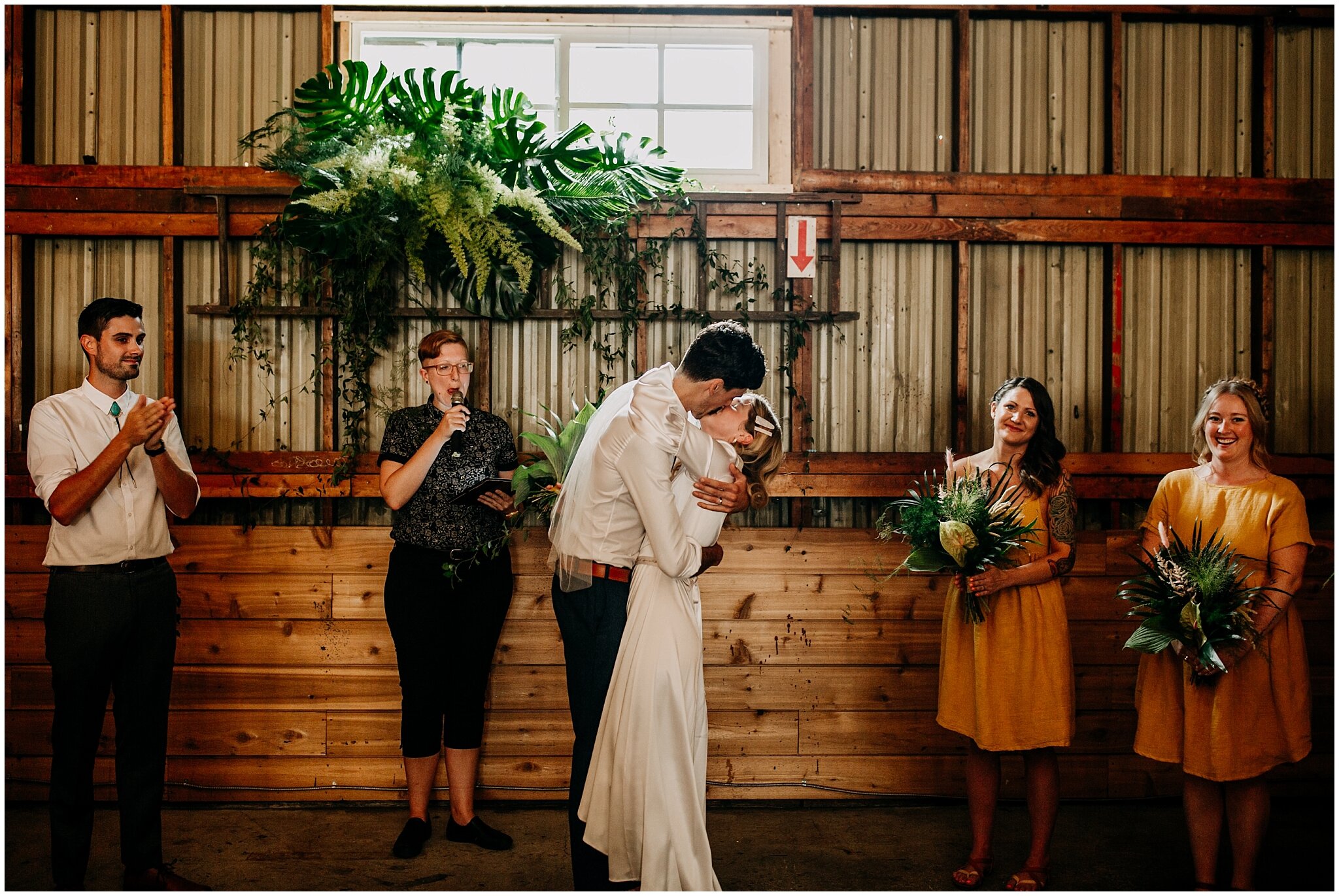 bride and groom first kiss at ellis building wedding ceremony