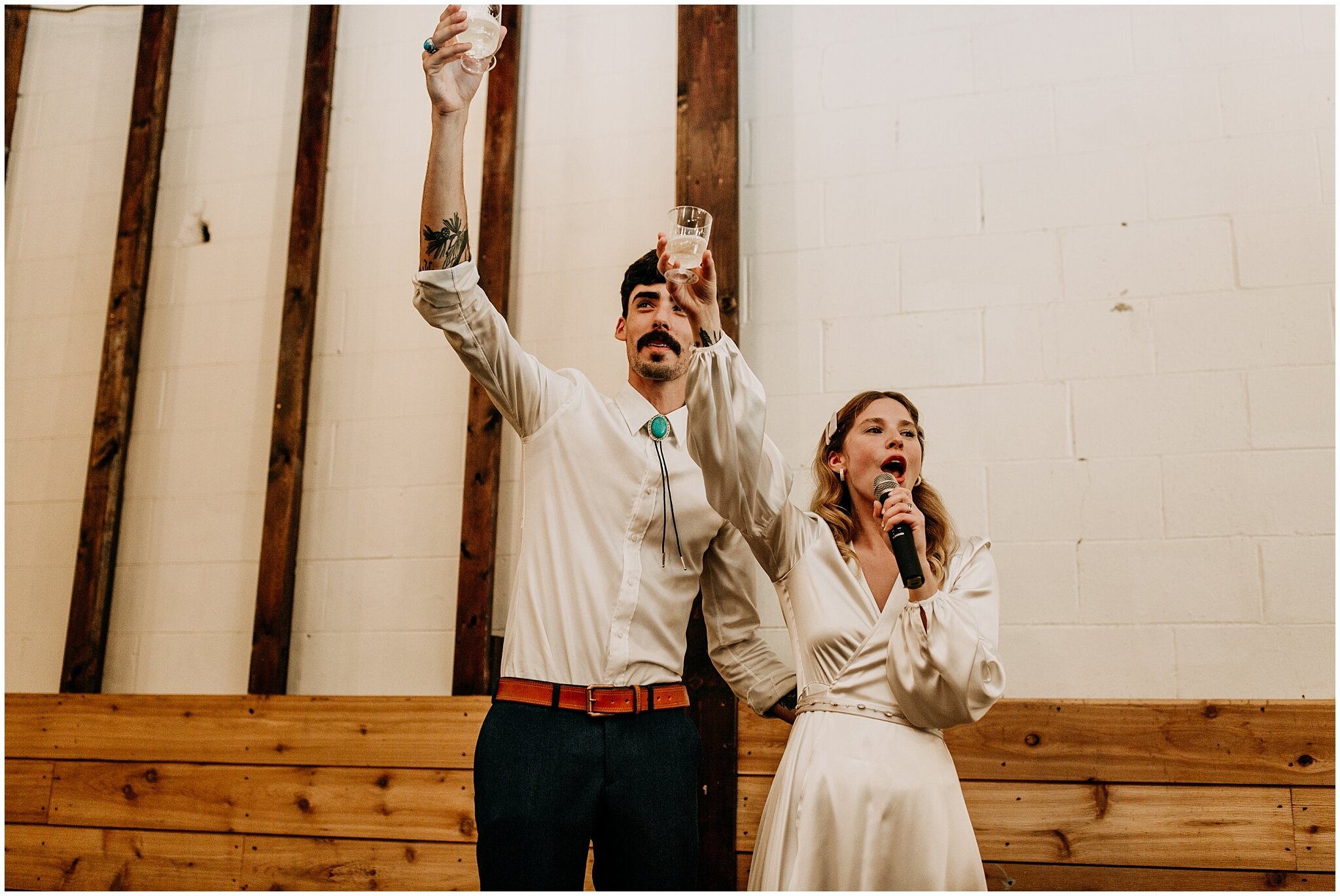 bride and groom toast at reception in ellis building
