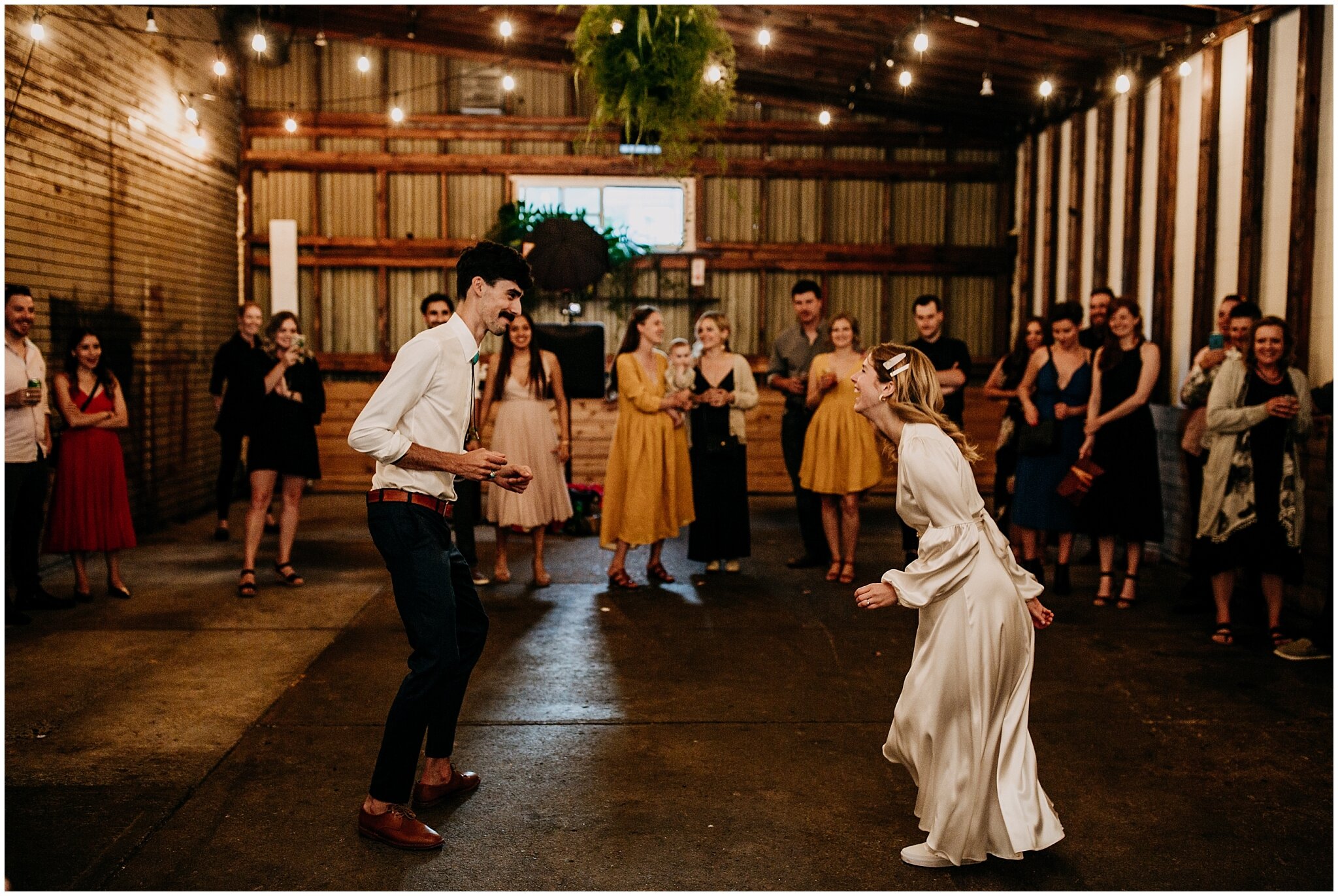 bride and groom fun first dance at ellis building wedding