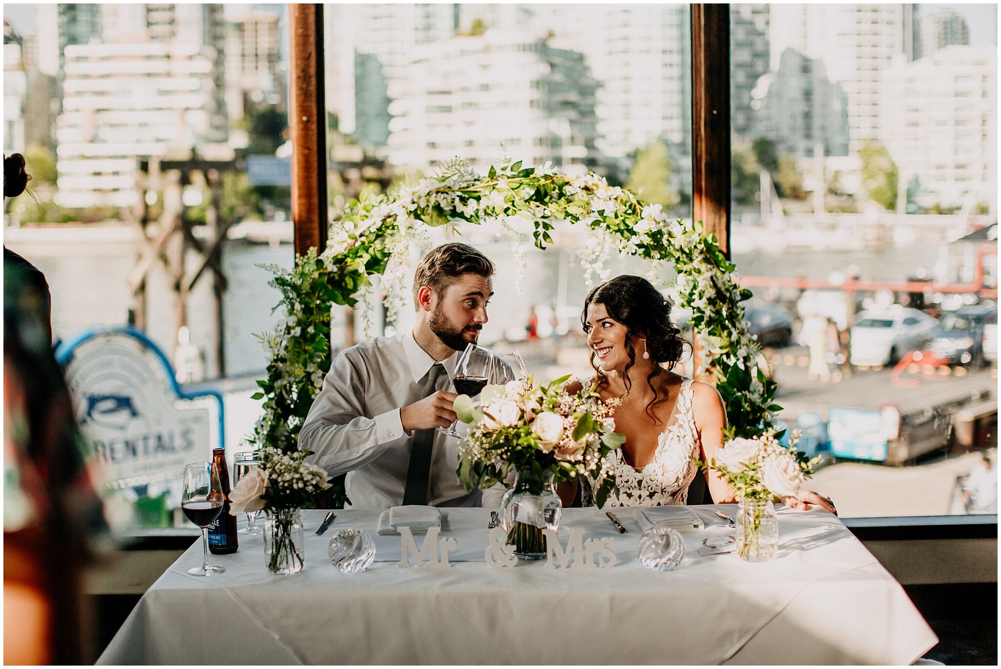 bride and groom cheers during reception at bridges restaurant wedding