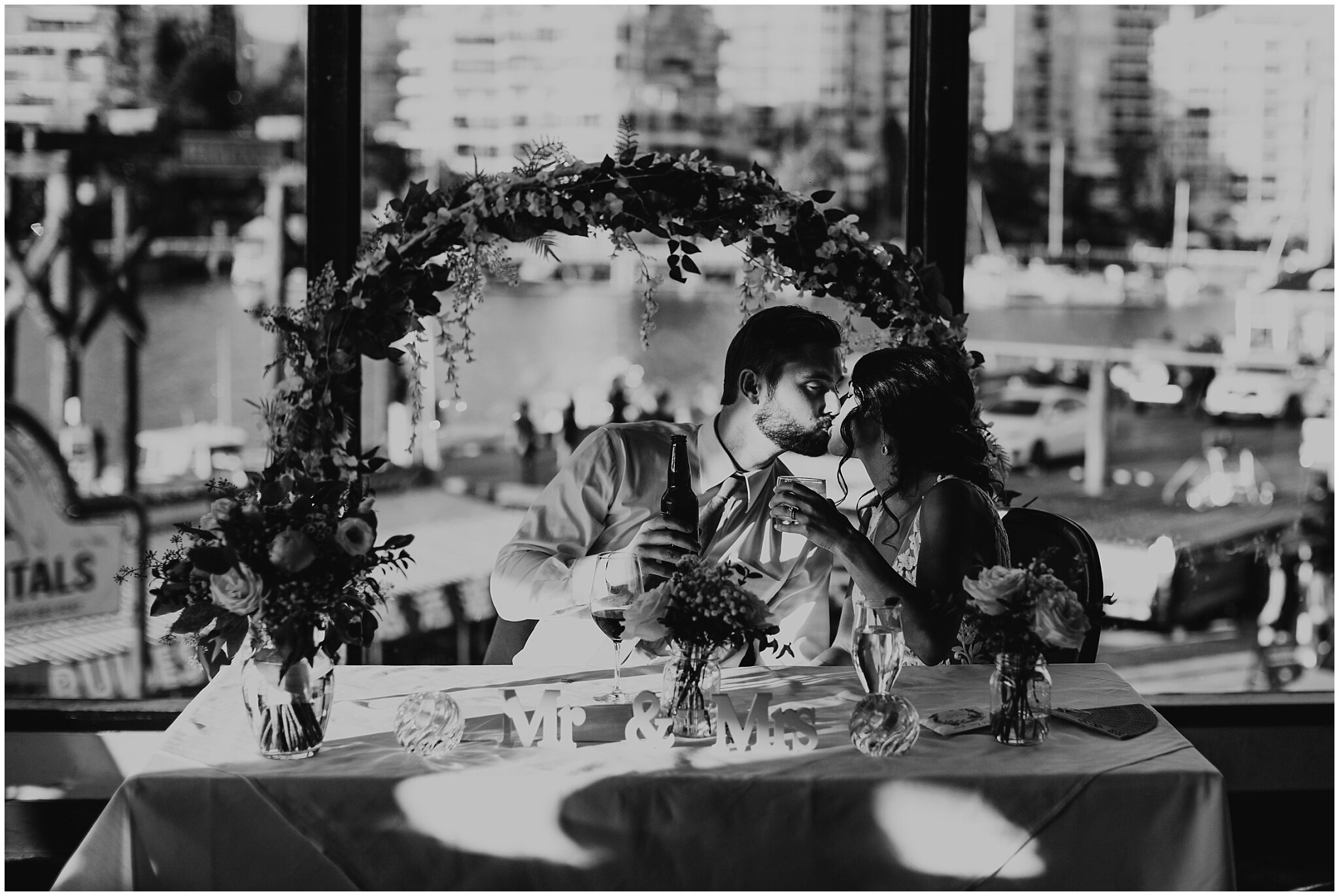 bride and groom kiss during bridges restaurant wedding