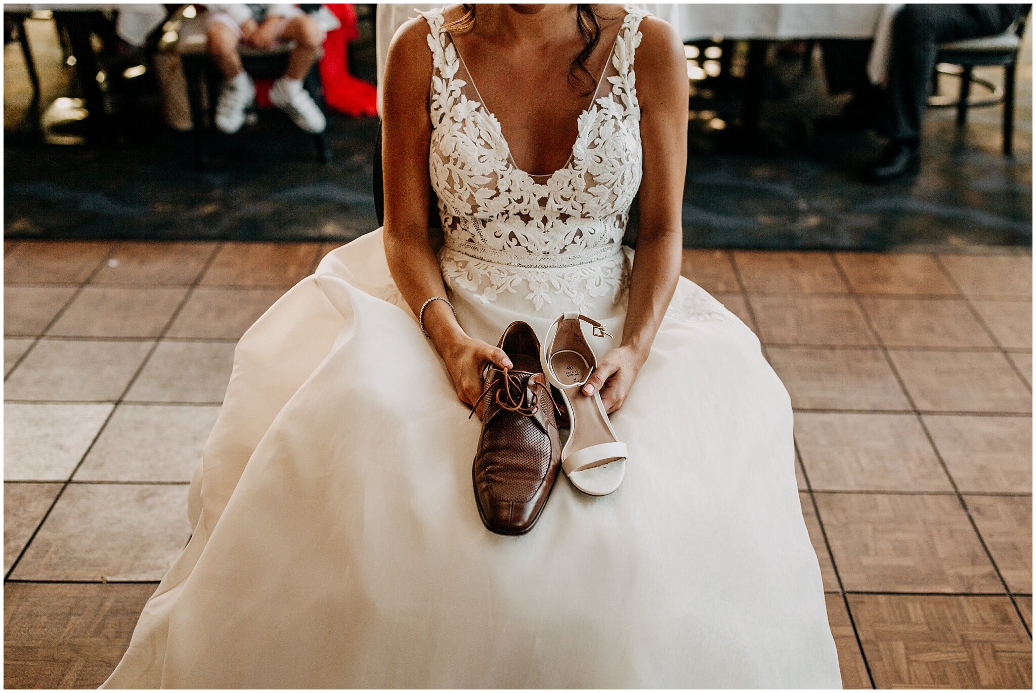 bride holding shoes for shoe game at bridges restaurant wedding