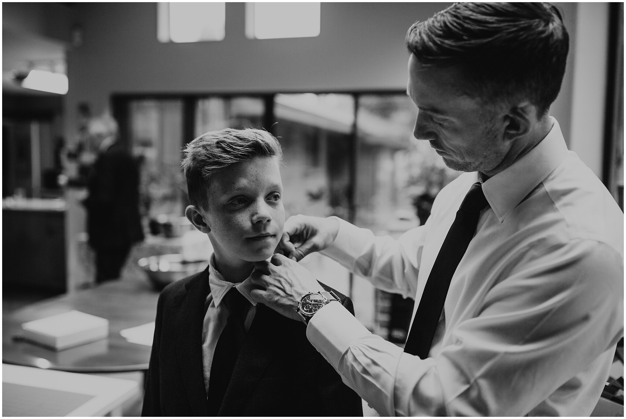 groom getting ready with son for settlement building wedding