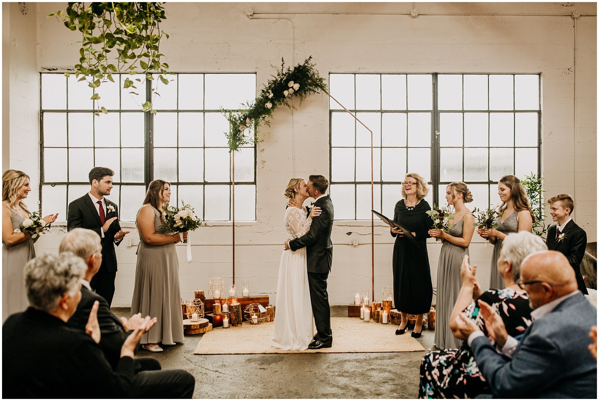 bride and groom first kiss at settlement building wedding 