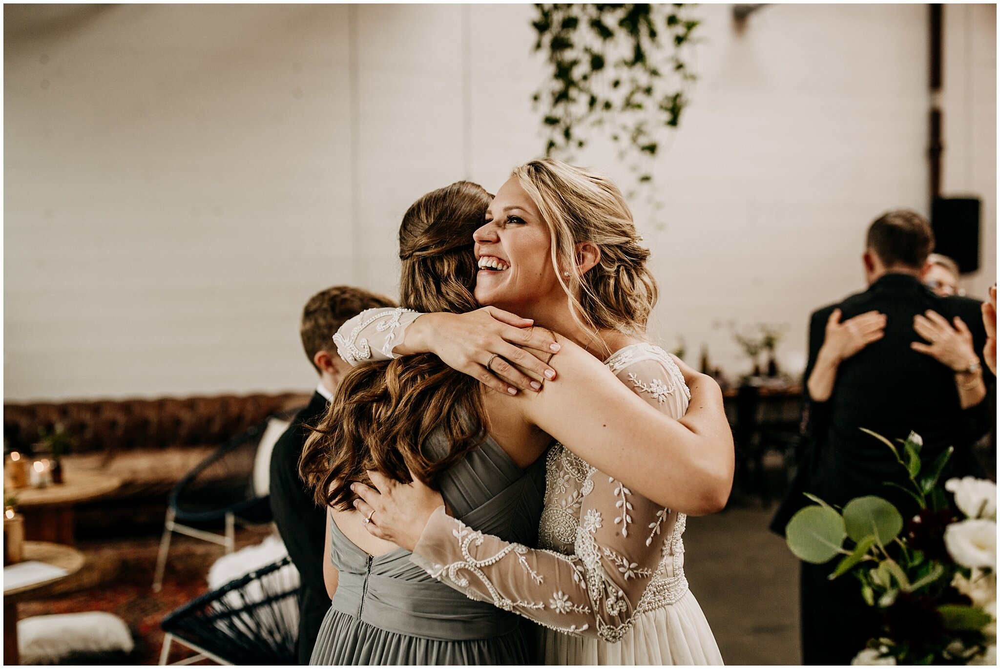 bride hugging step daughter at settlement building wedding