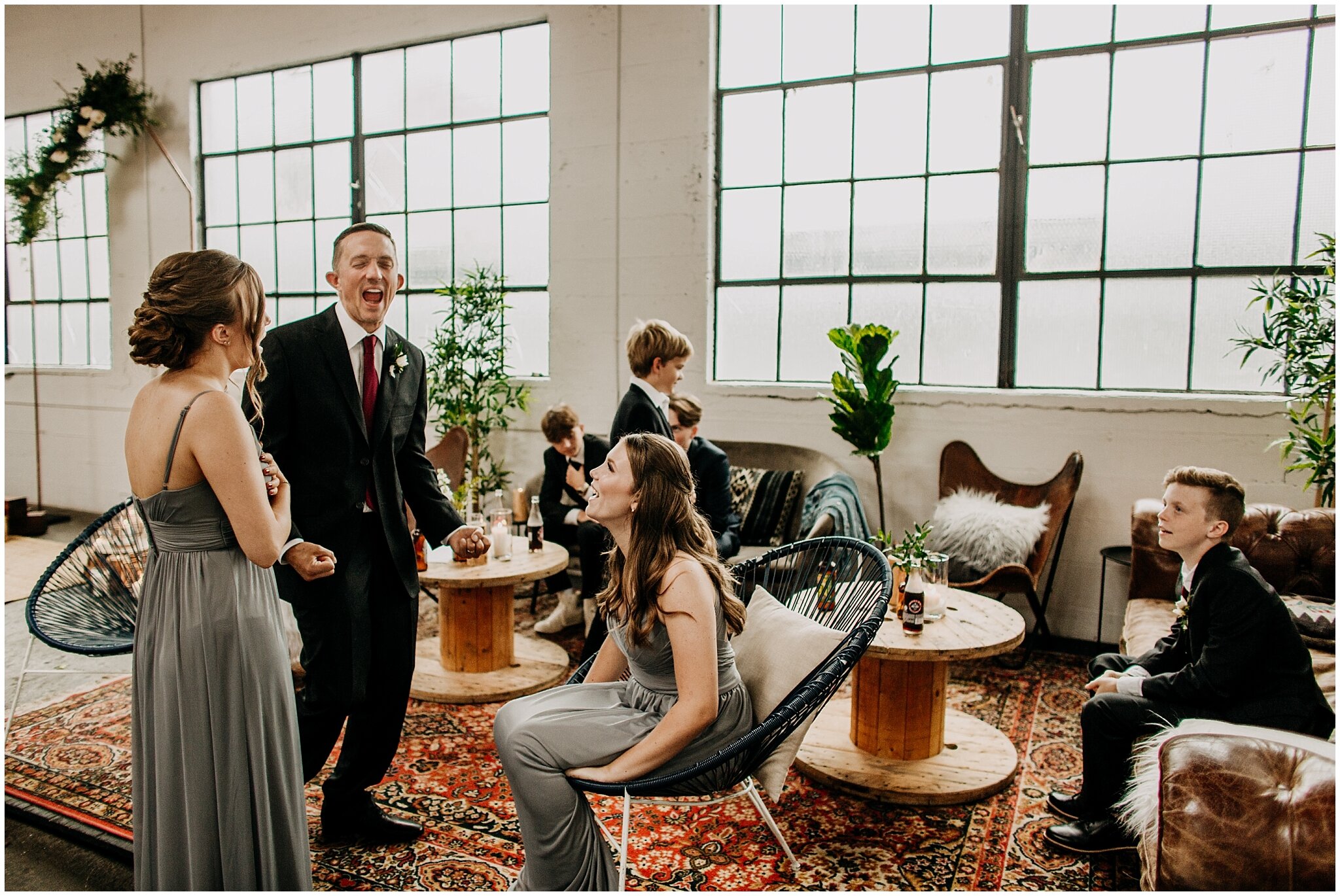 candid moment of groom talking with his kids at settlement building wedding