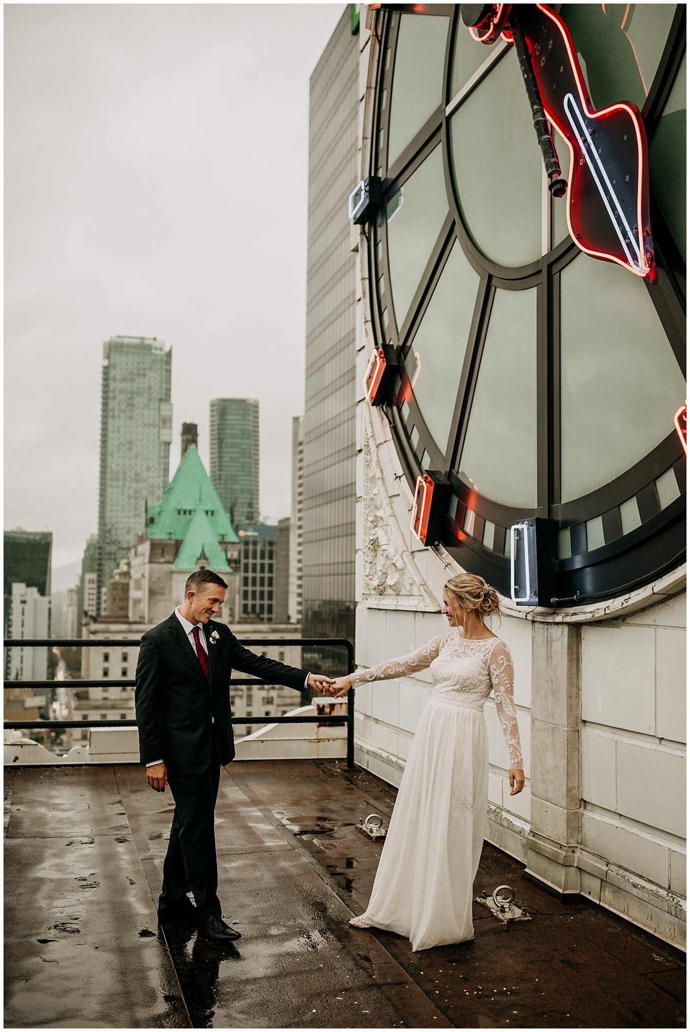 bride and groom portrait on vancouver block clock tower rooftop 