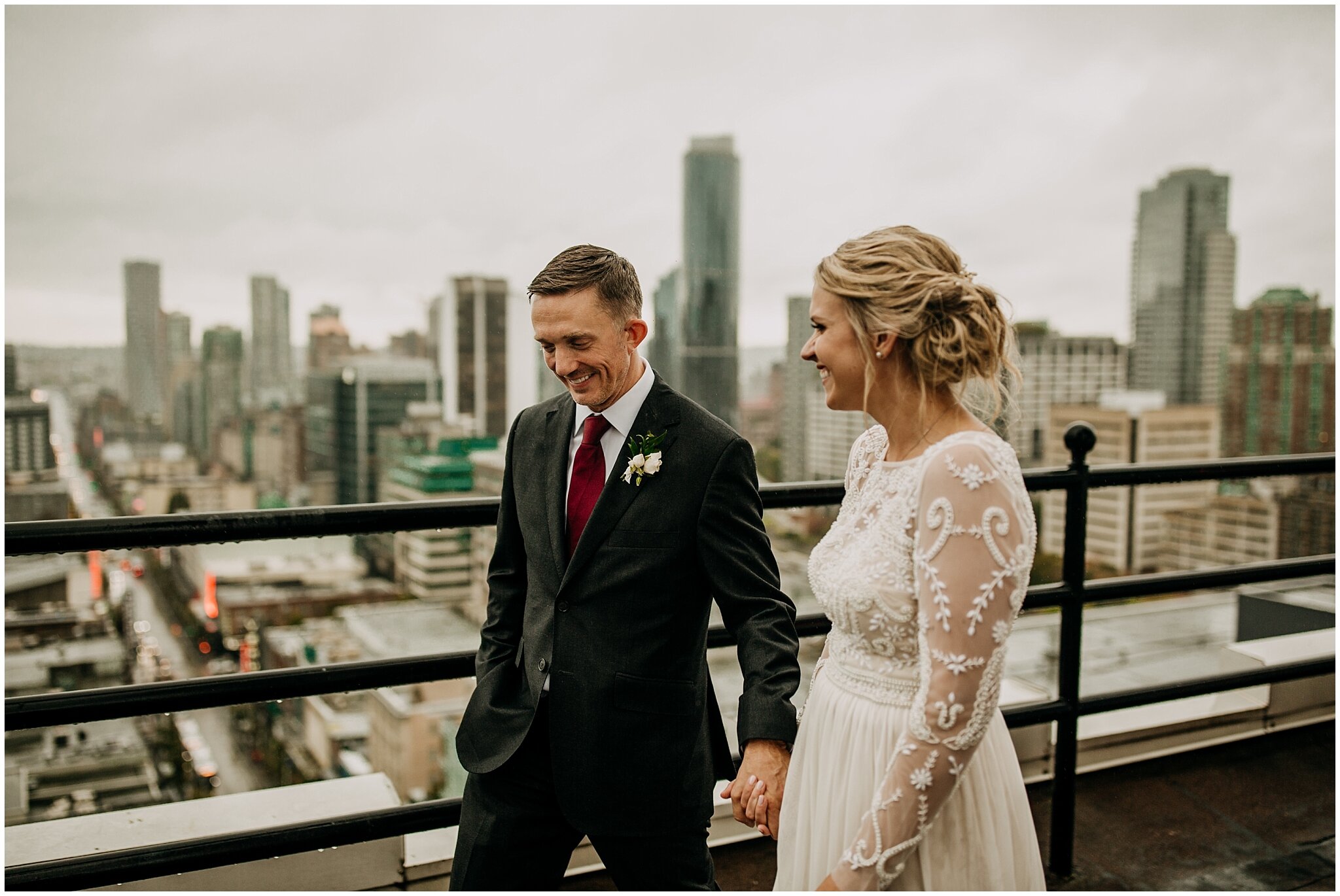 bride and groom walking on vancouver block clock tower rooftop