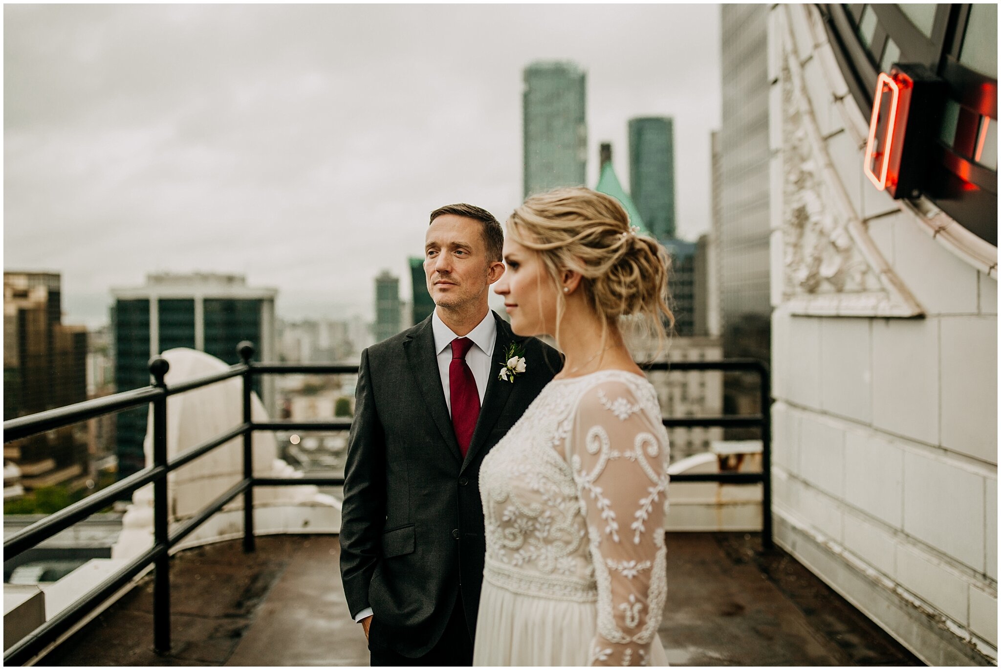 bride and groom portrait on vancouver block clock tower rooftop