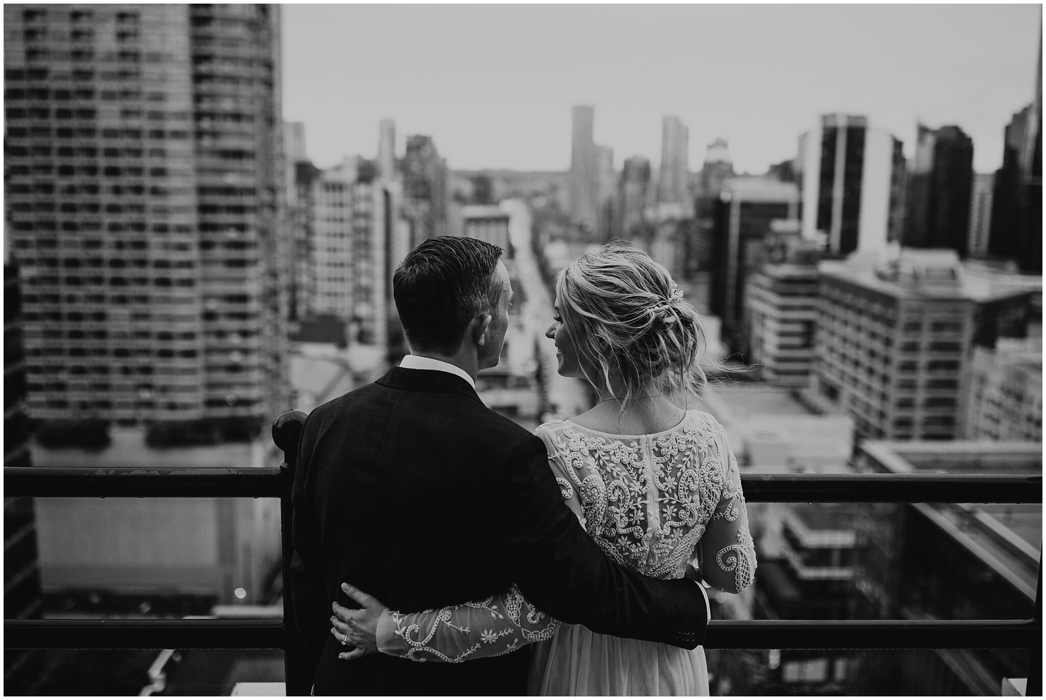 bride and groom on vancouver block building rooftop with city view