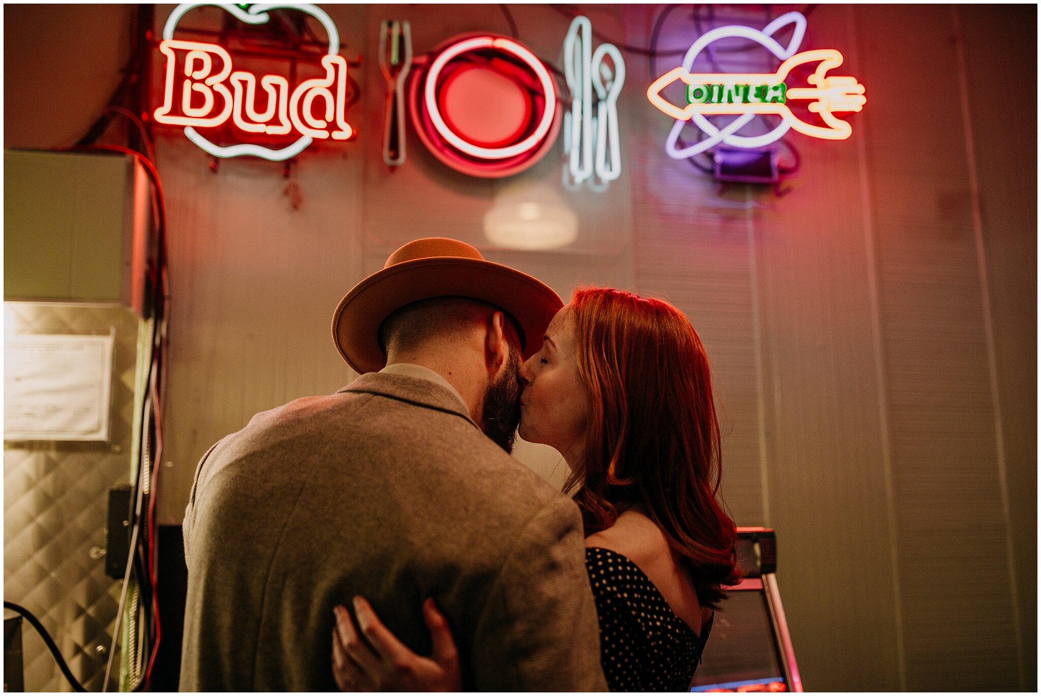 couple kissing in front of juke box and neon lights in the templeton