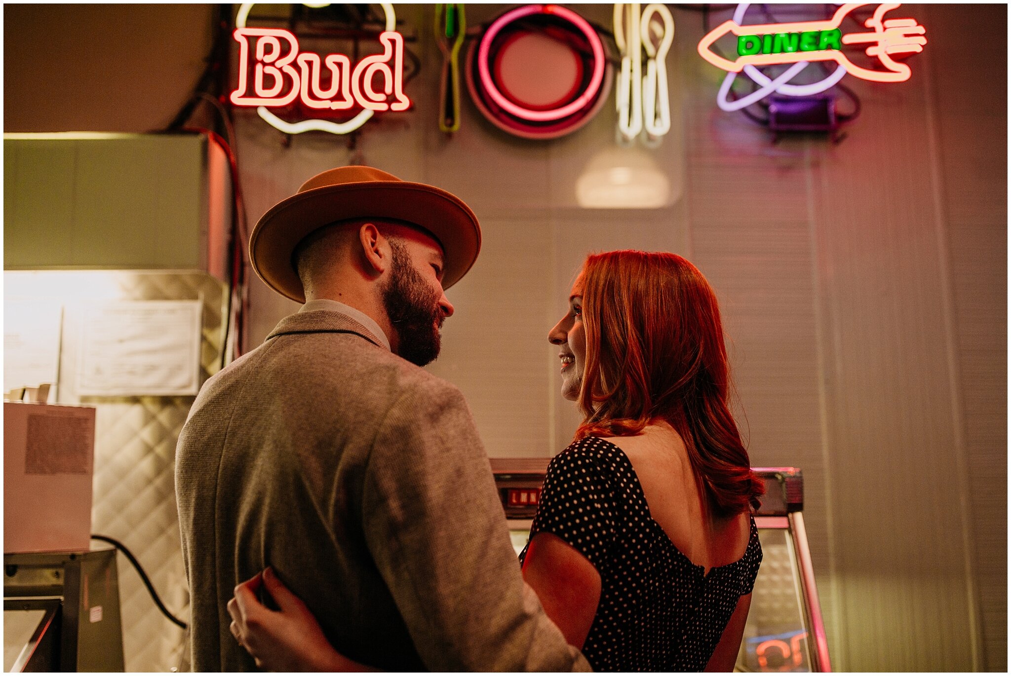 couple engagement photo in the templeton vancouver with neon lights