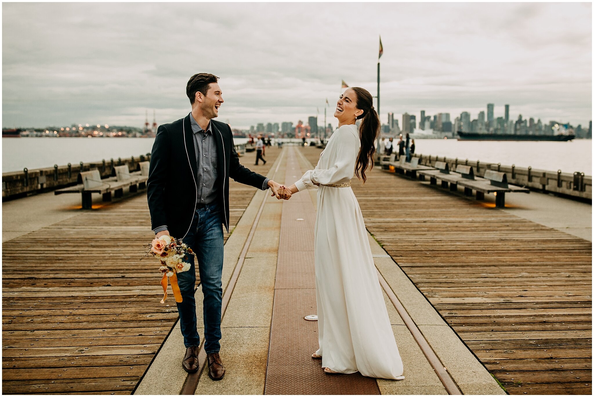 bride and groom playful portrait on lonsdale quay for rocky mountain bride styled shoot
