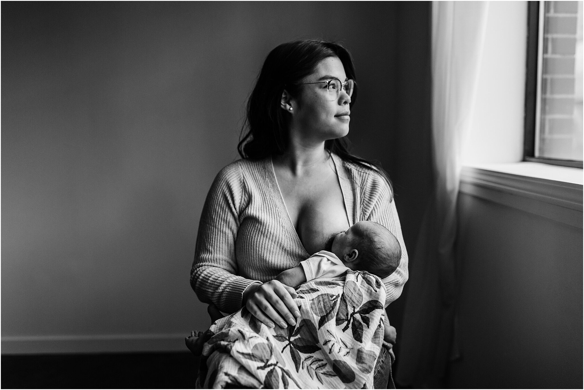 black and white studio portrait of mom breastfeeding her baby in vancouver