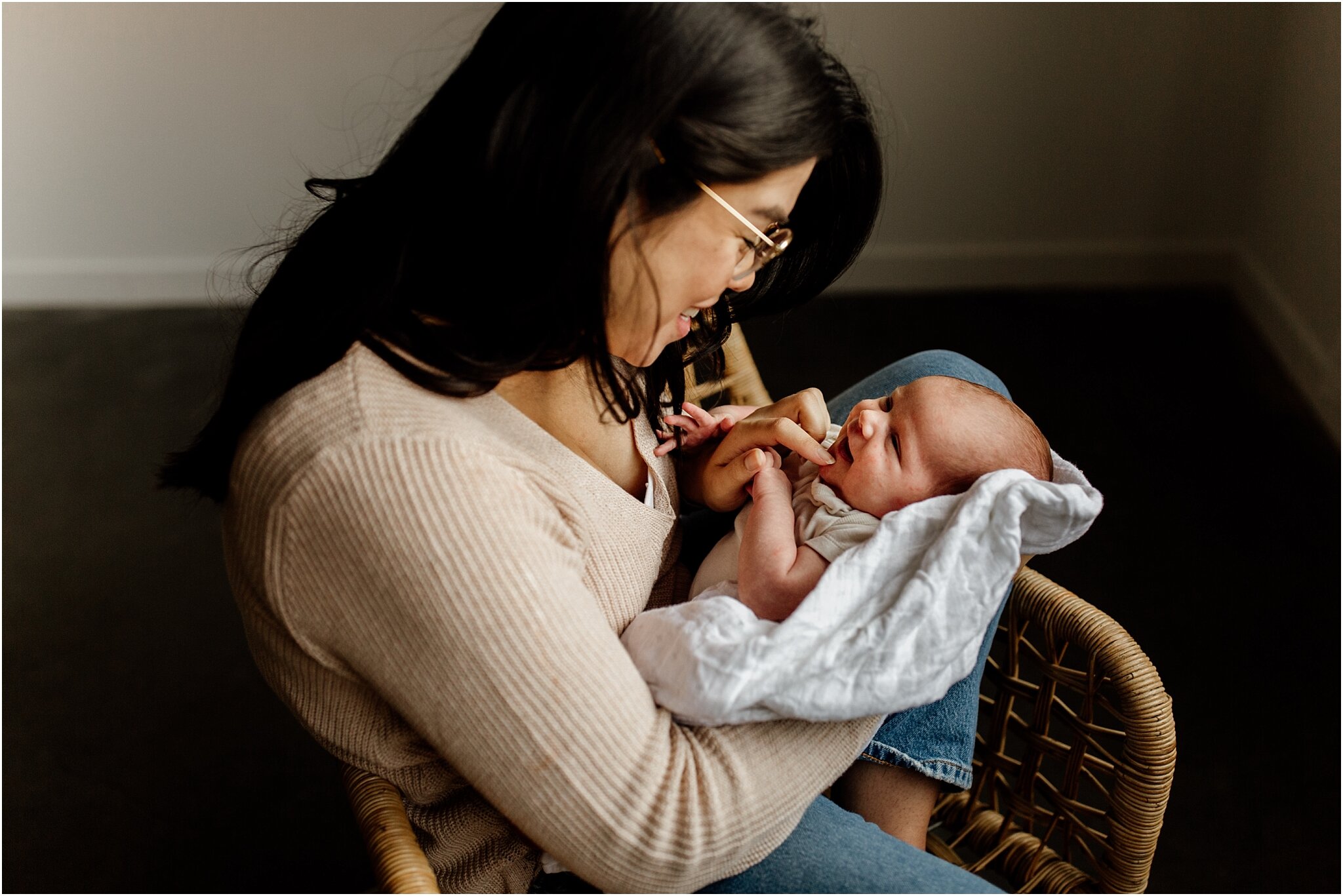 studio portrait of mom holding smiling baby in vancouver photo studio