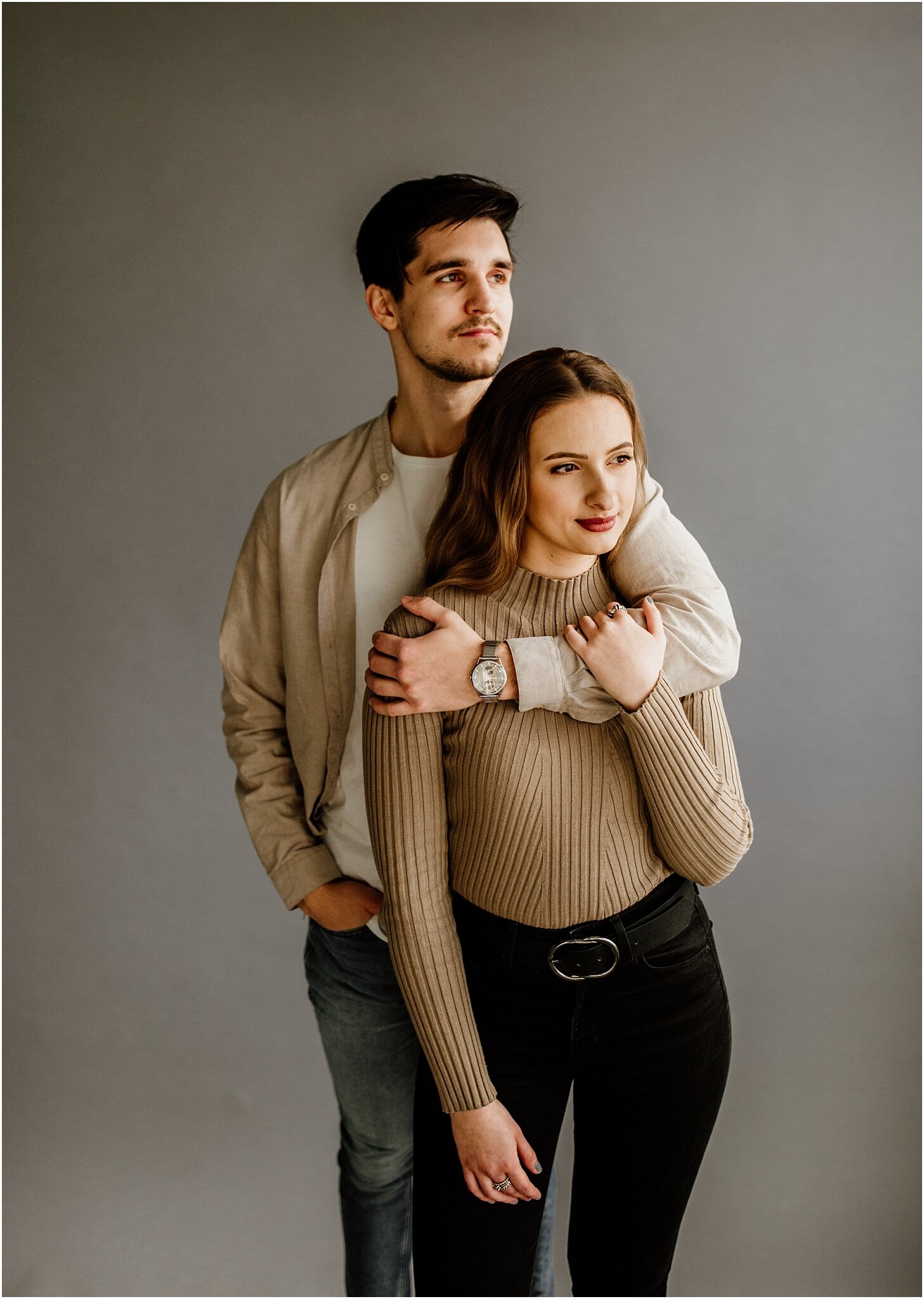 editorial natural light portrait of couple with grey backdrop