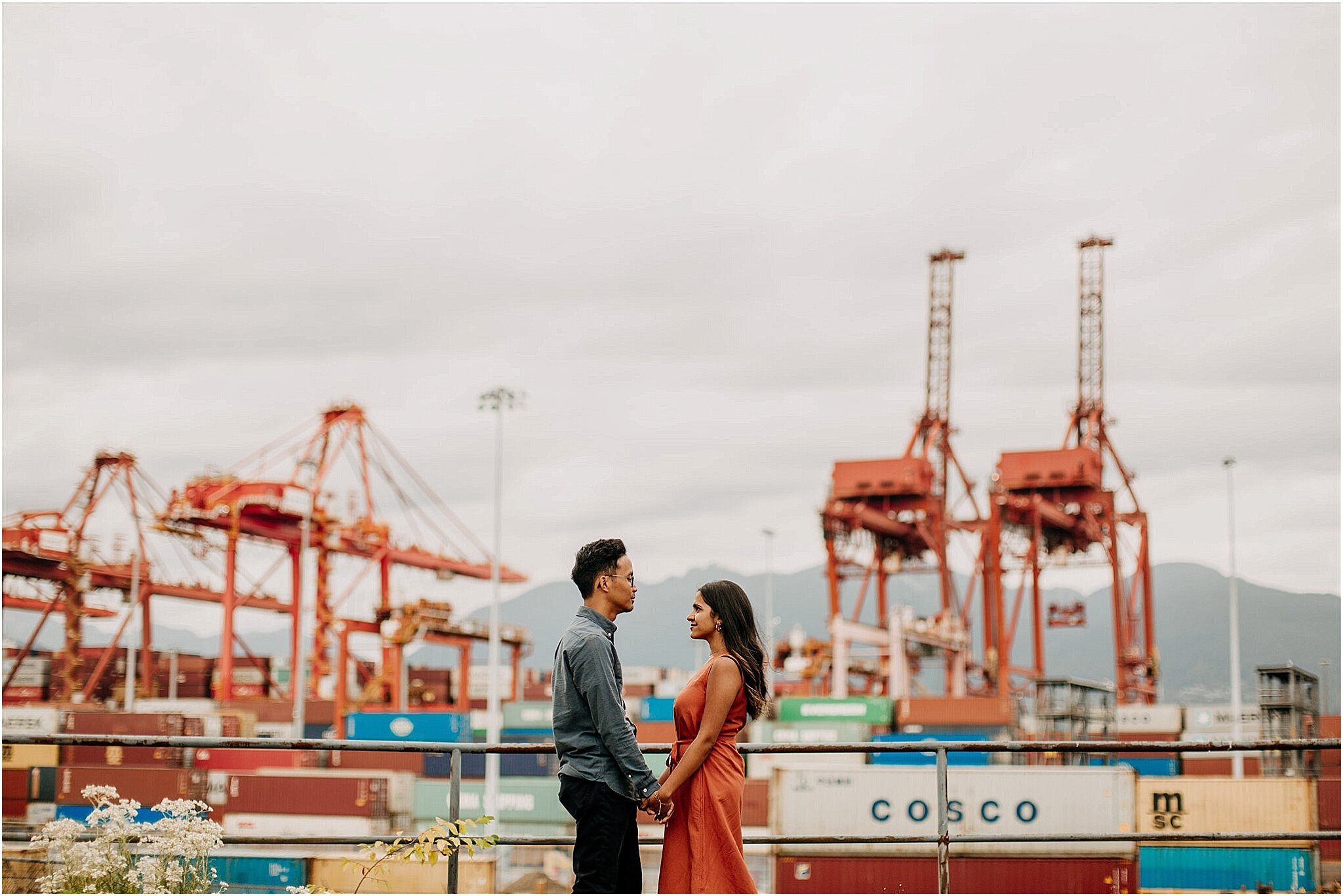 couple holding hands in industrial area Railtown