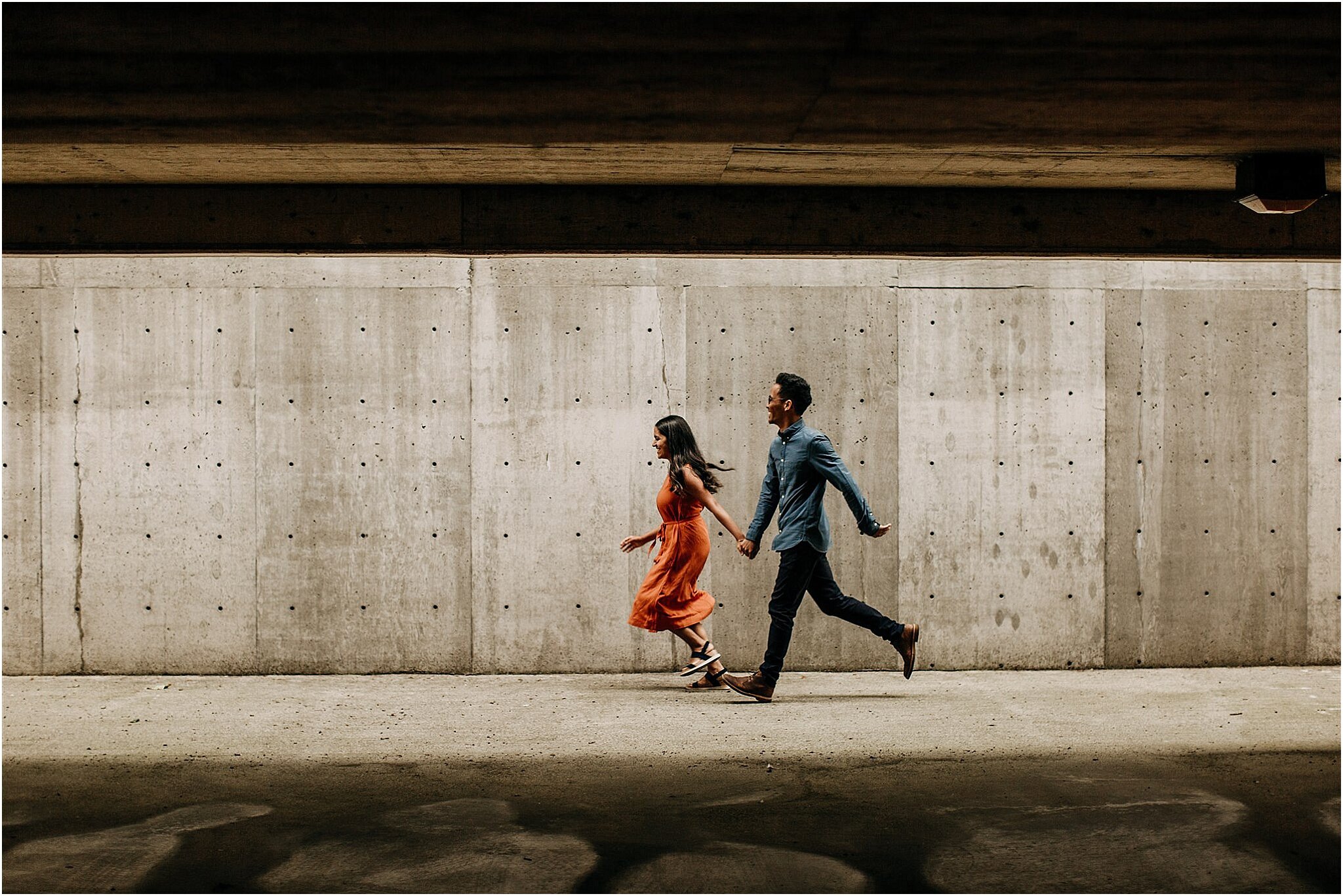 couple running in industrial parkade East Vancouver