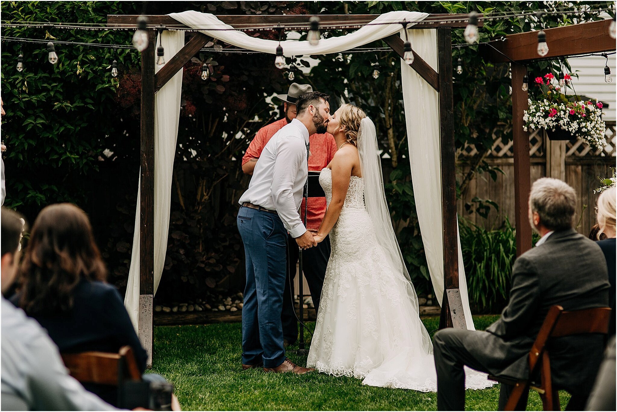 bride and groom kiss at end of ceremony in backyard wedding Surrey BC