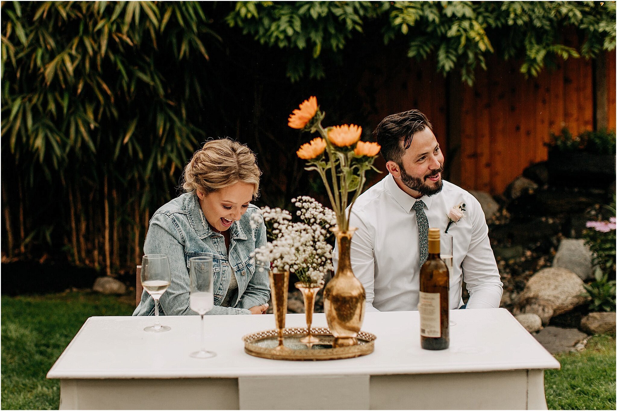 bride and groom laughing at speeches in intimate backyard wedding Surrey BC