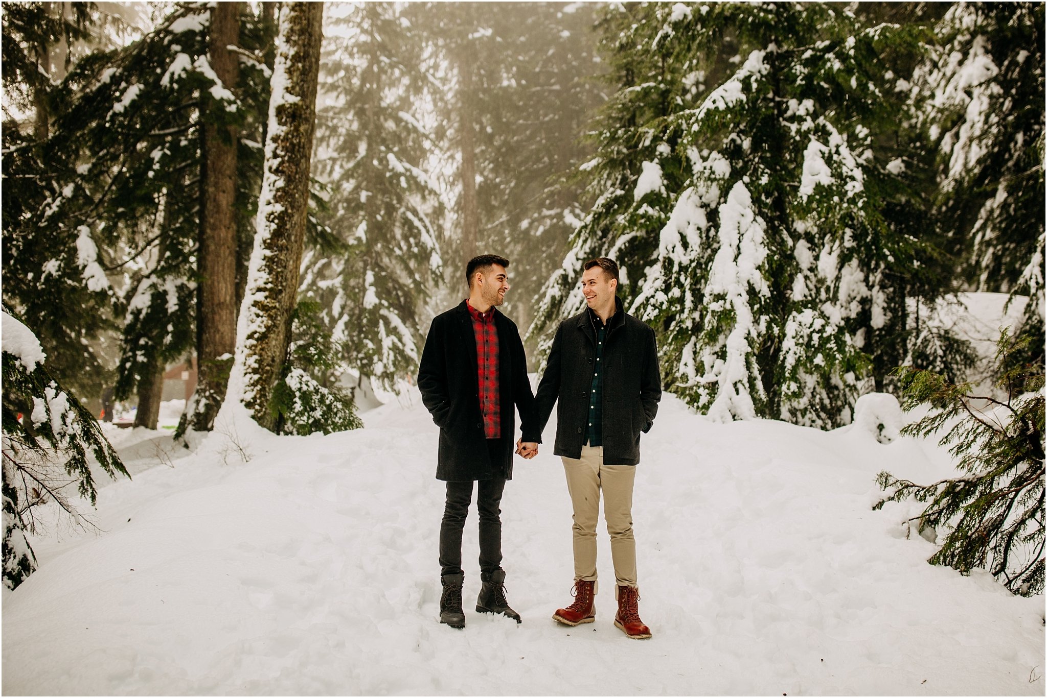 couple holding hands on snowy trail mount seymour