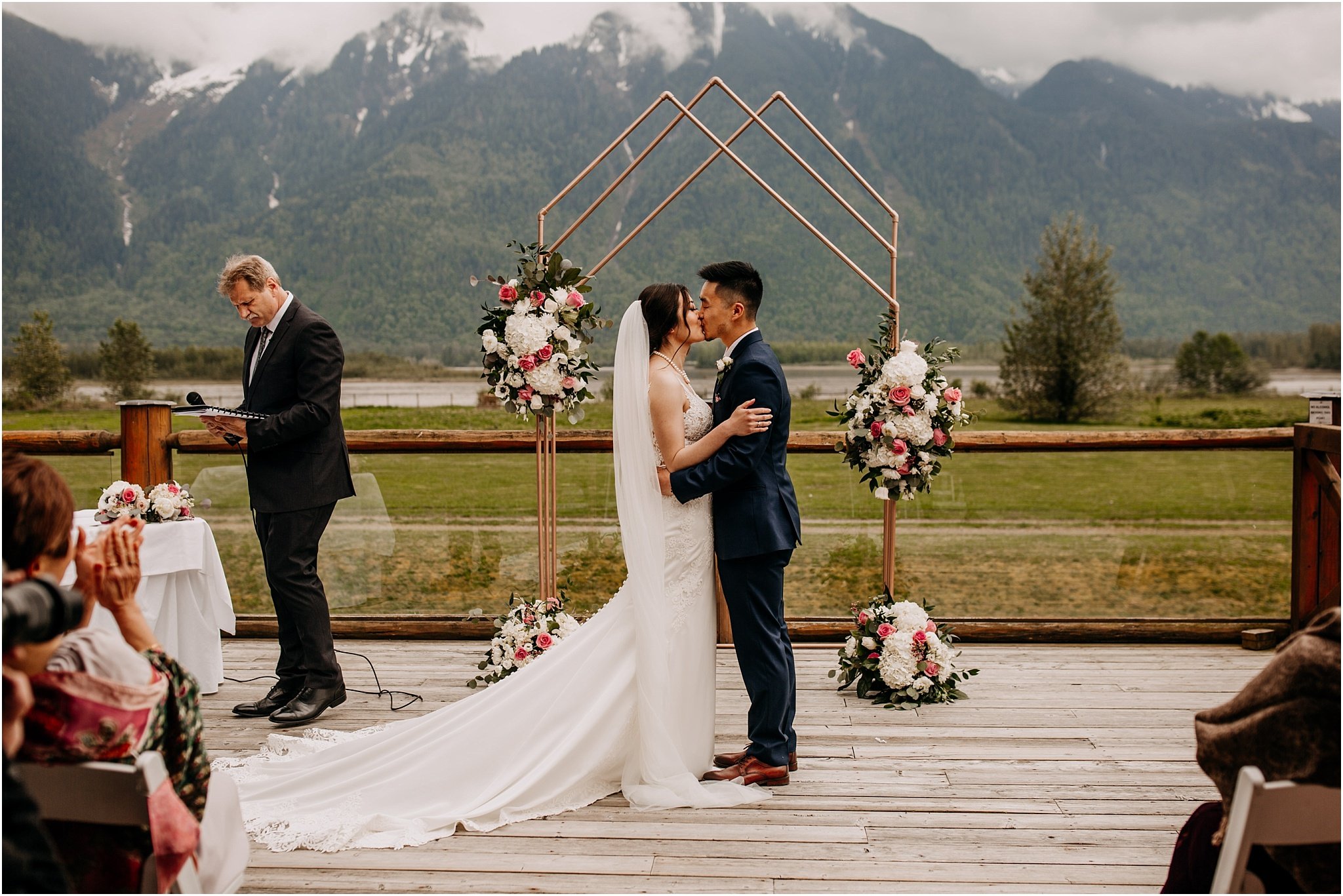 bride and groom first kiss at Fraser River Lodge Agassiz BC