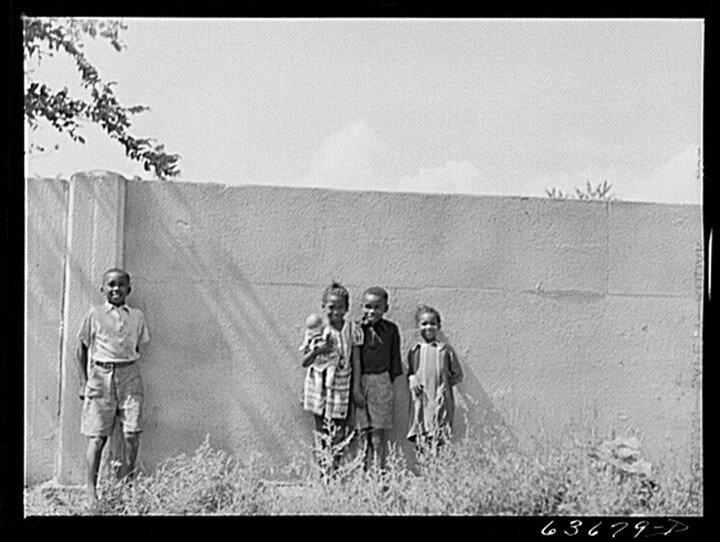 Children pictured in front of the 8 mile wall aka the &quot;Wailing Wall&quot;.⁣
⁣
The wall stood 6 feet tall and went on for only about a half a mile. It was erected in the 1940s in order to separate black homeowners and white homeowners.⁣
⁣
Learn m