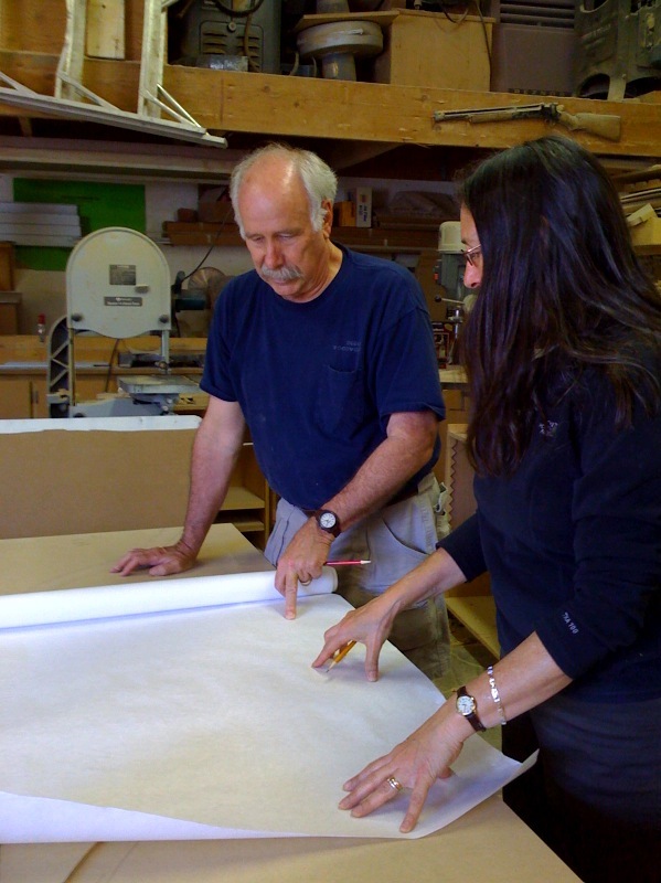 Michelle confers with master furniture maker, Mike Deegan on a project