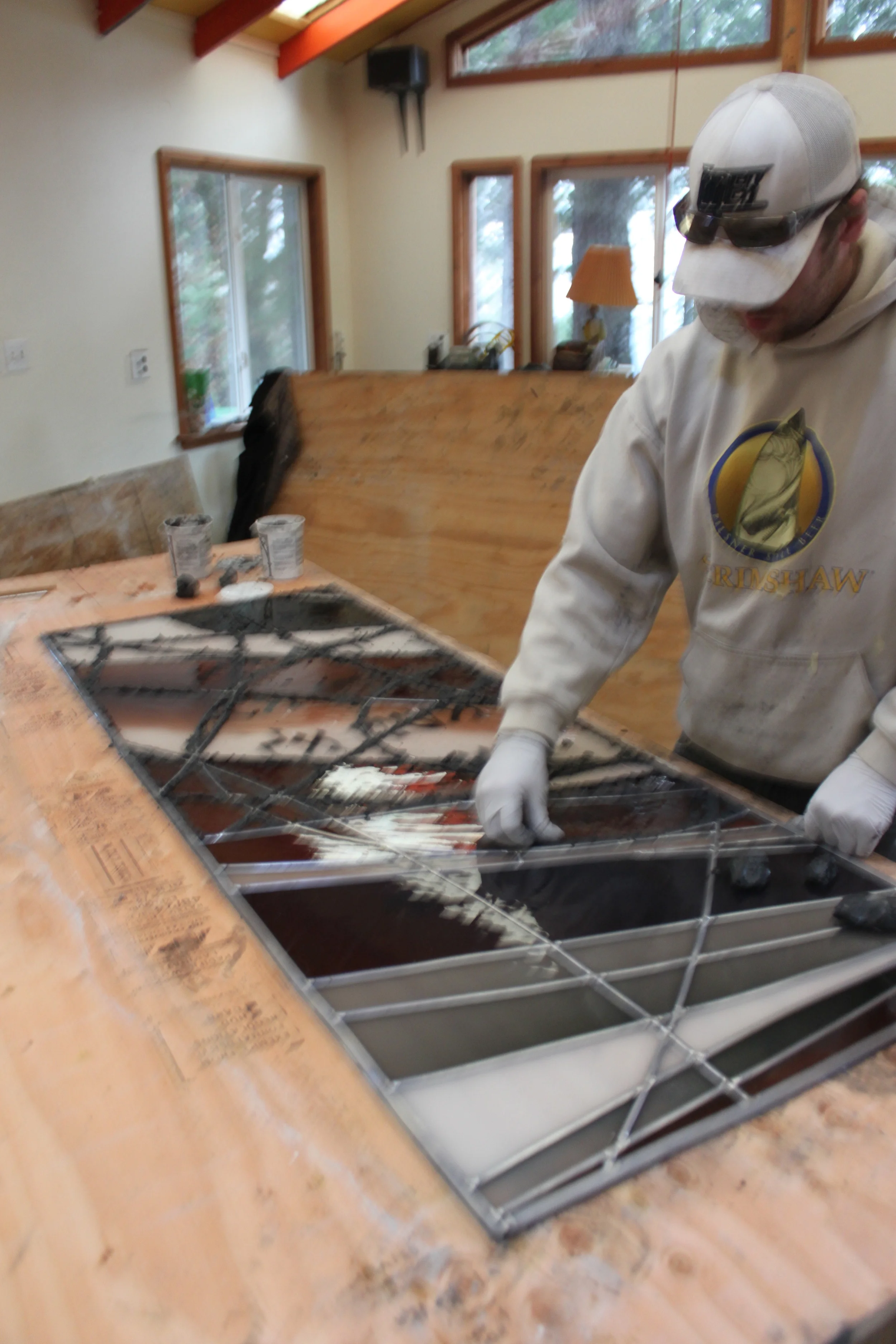 Nico works on glazing a panel destined for an ark door.