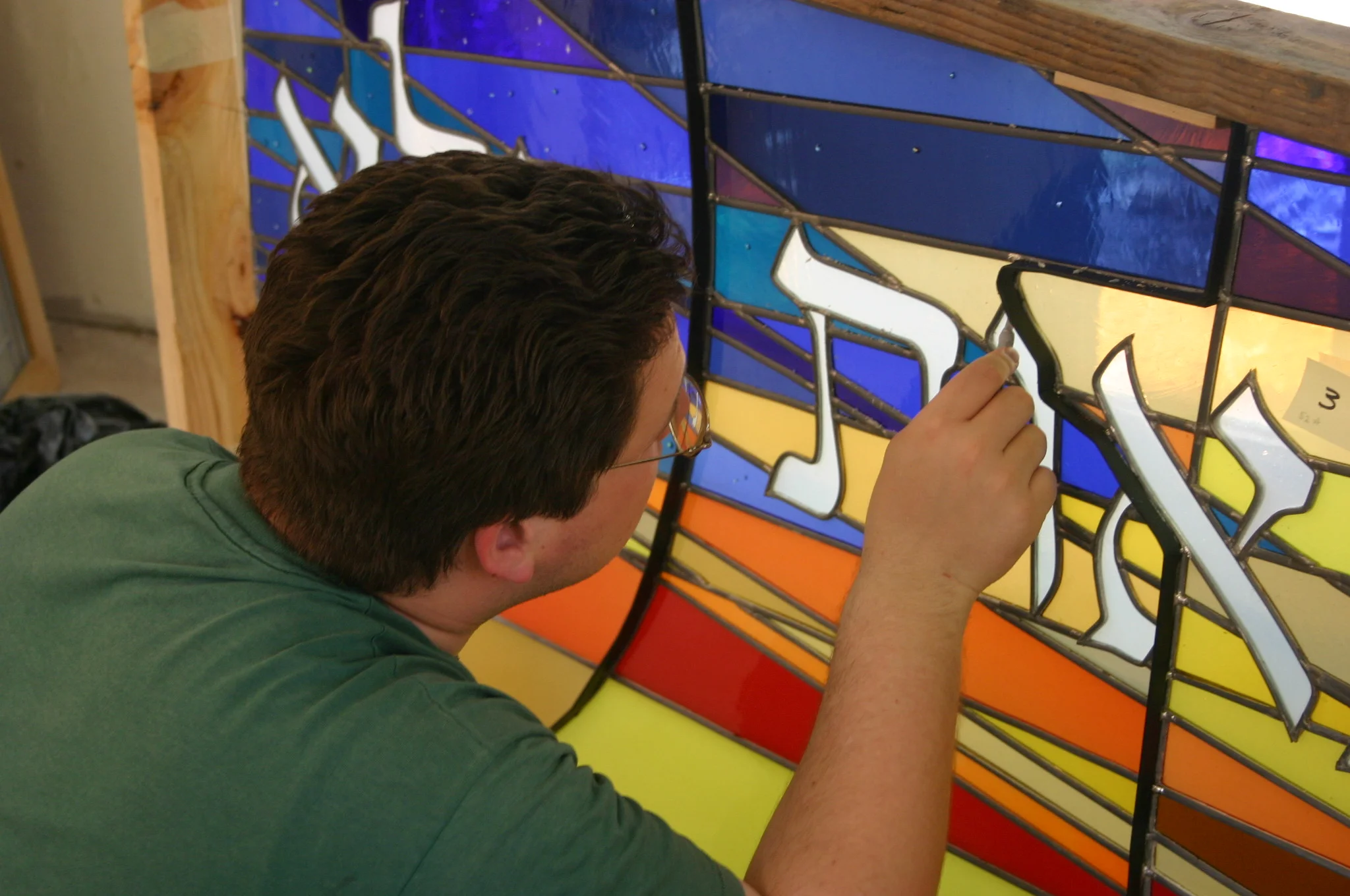  Nathan performs a final cleaning on a finished panel. 