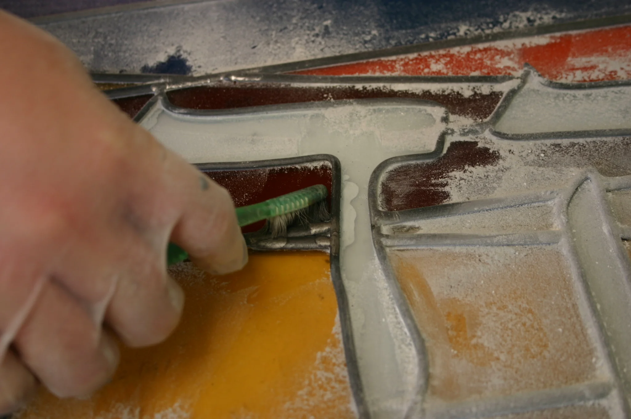  Removing excess putty with a fid. 