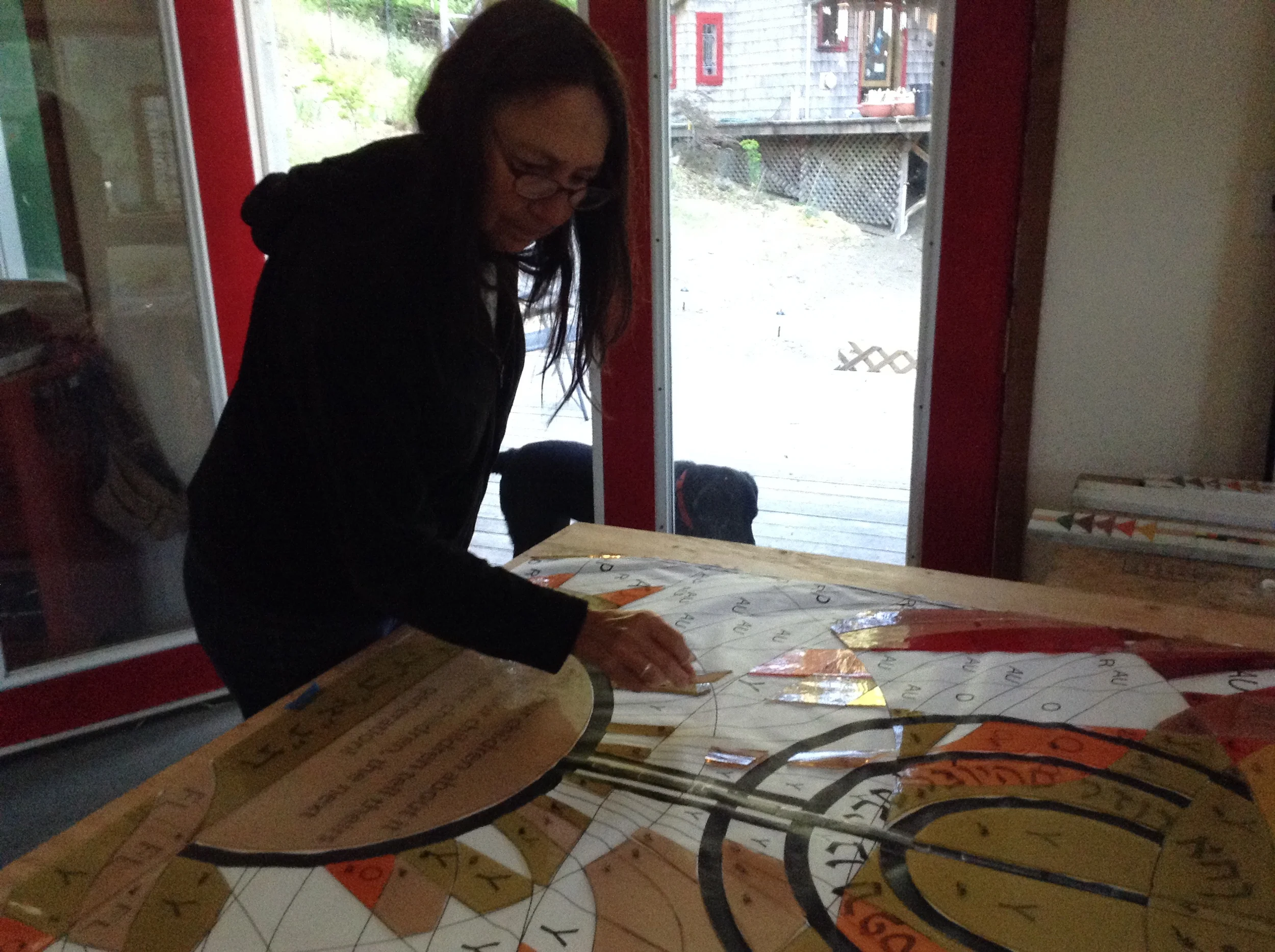  Michelle lays a piece of the window on the duplicate pattern. 