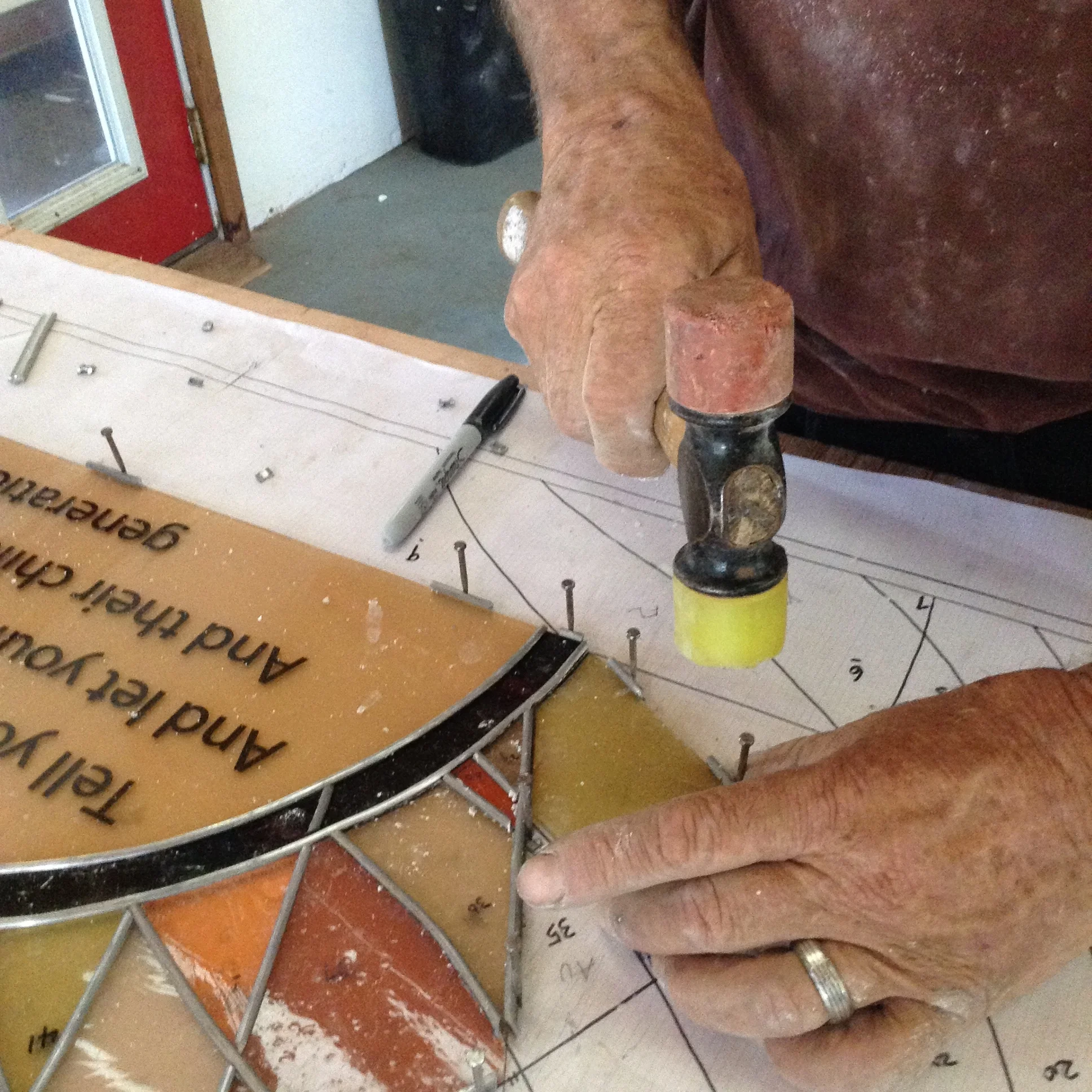 Lead and glass are held in place temporarily with glazing nails.