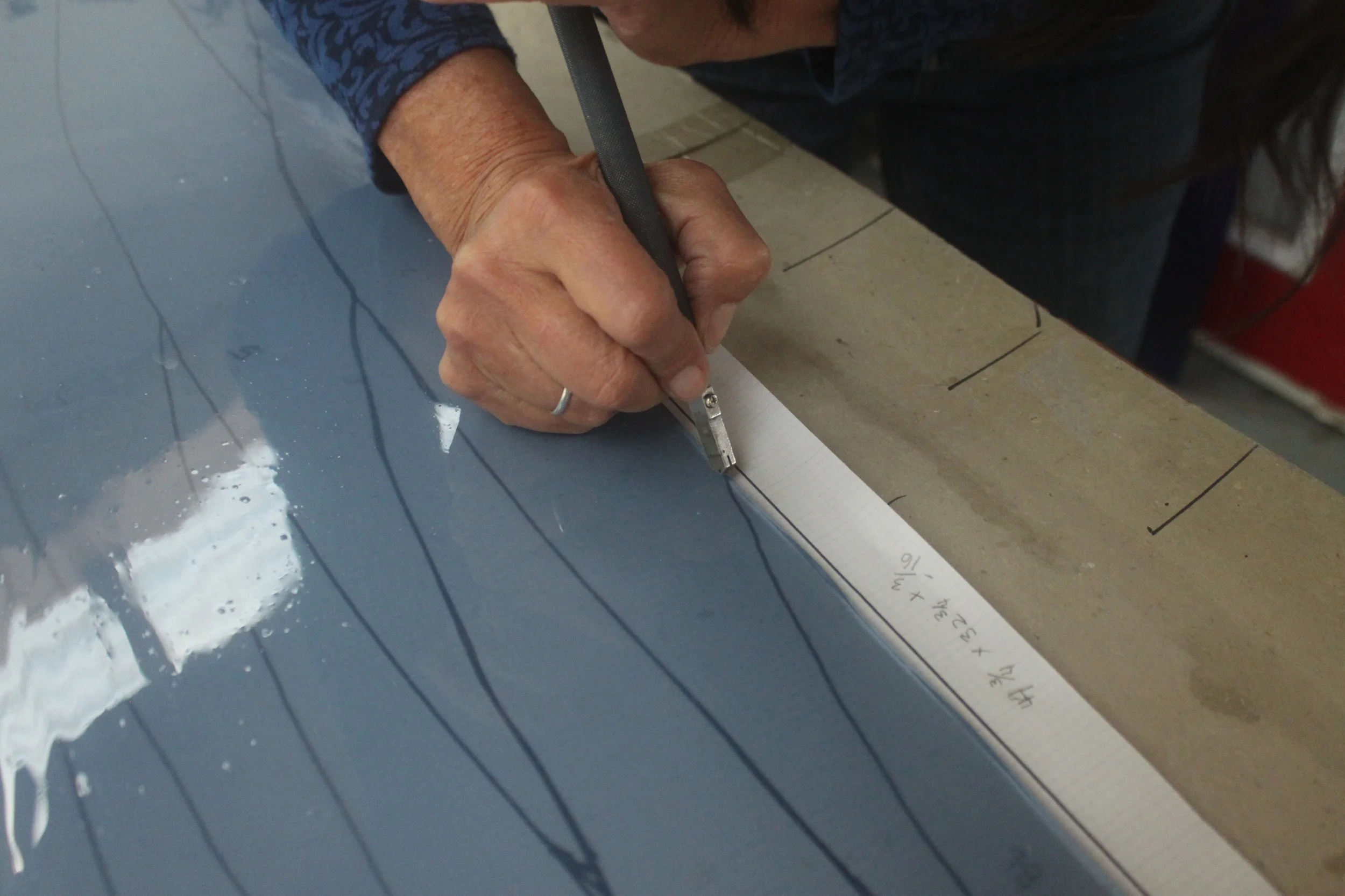  Michelle pushing the glass cutter over the pattern to break out one more piece for the Bima windows. 