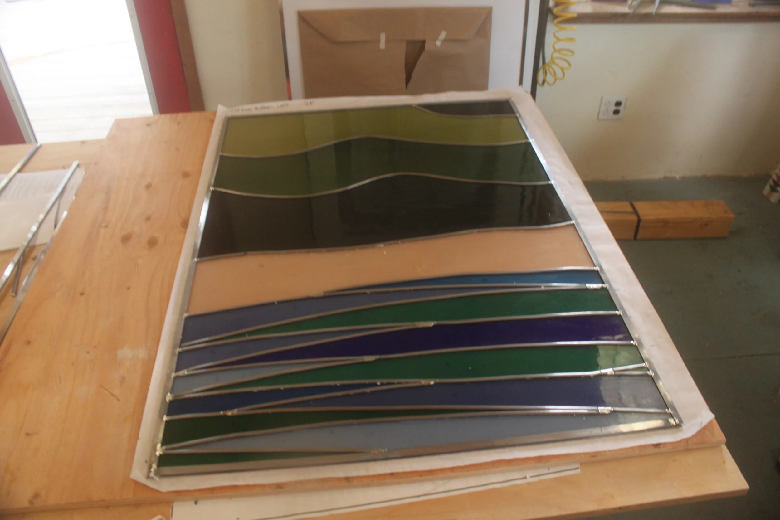  A panel, assembled, soldered and glazed on one side. 