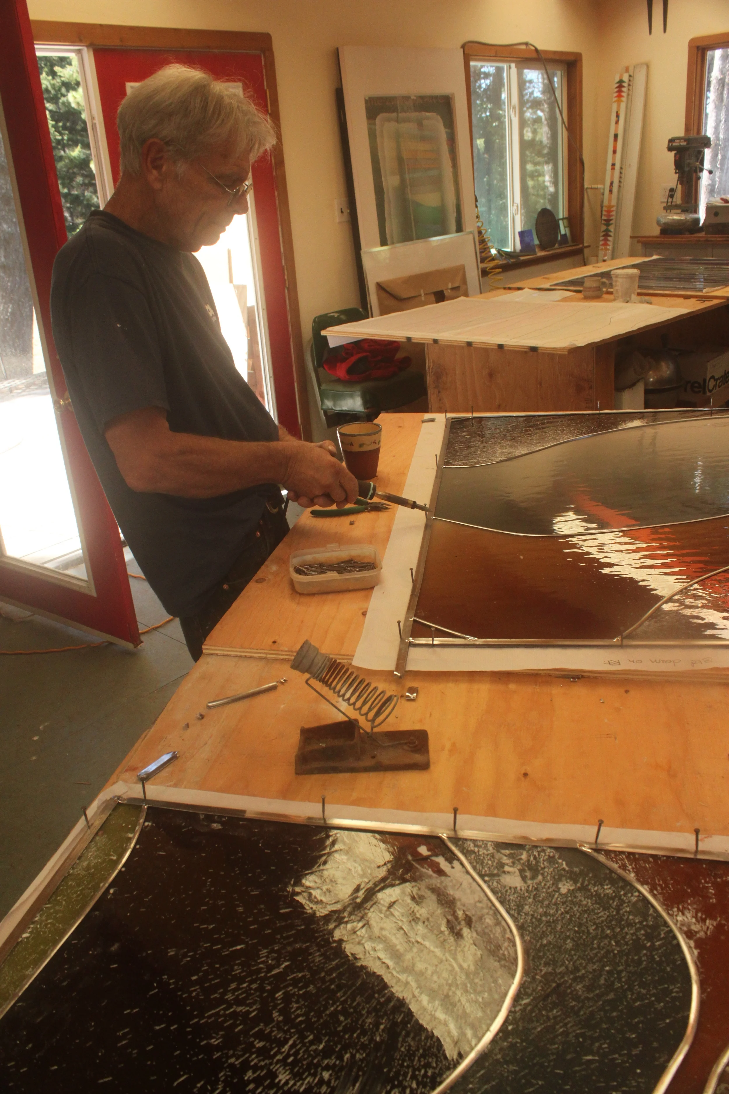 David works on soldering a panel.