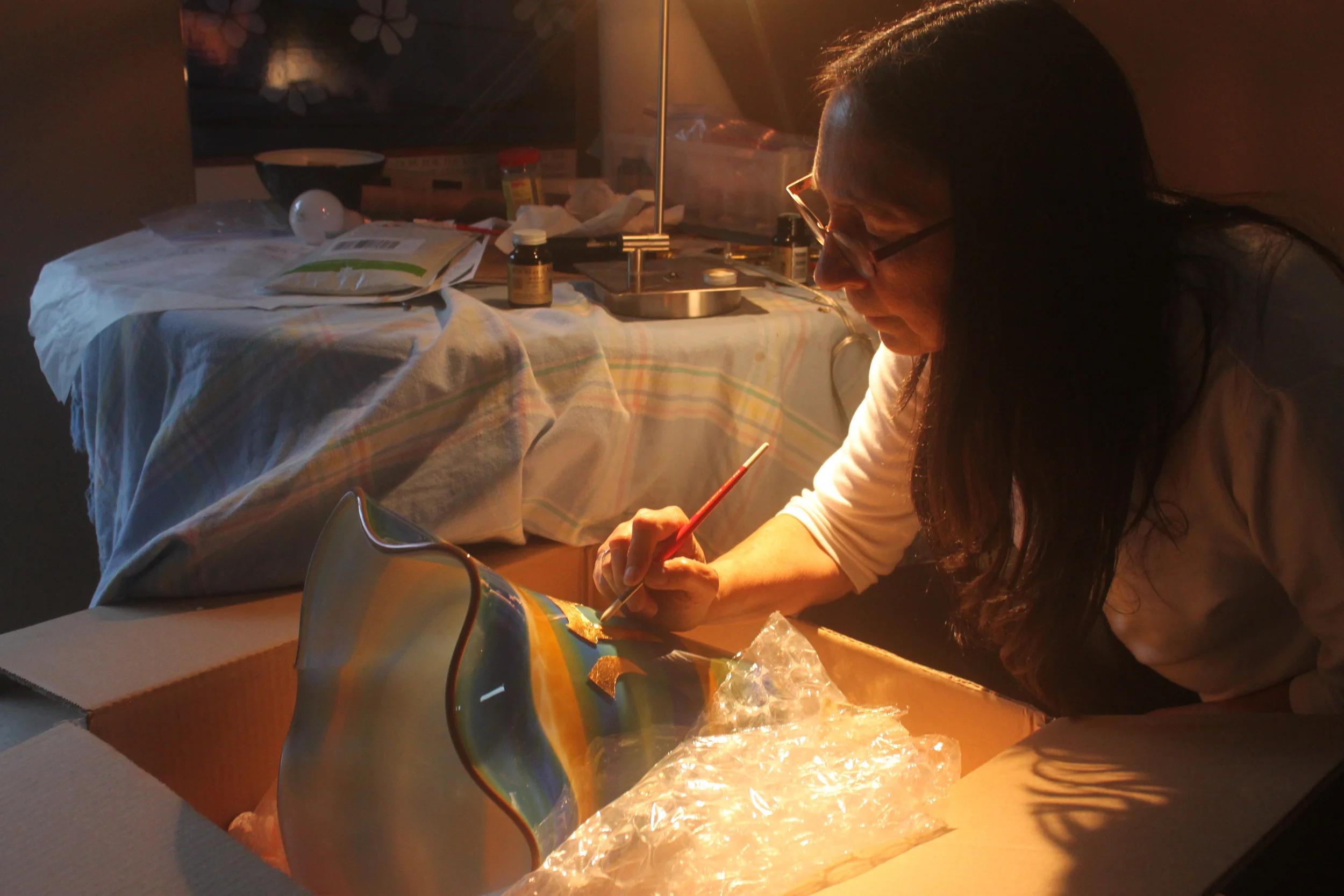  Michelle puts the finishing touches on the goldleaf letters of the Ner Tamid. 